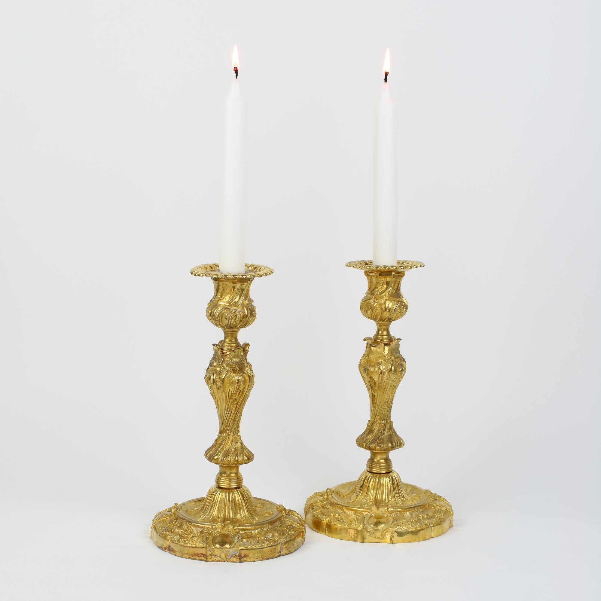 Mid 19th Century French pair of Louis XV gilt bronze candlesticks, made by Henri Picard/Paris: 

Baluster shaped stem standing on a broad round base decorated with curled cartouches, foliage and shell motifs. The stem displaying an unusual and rare