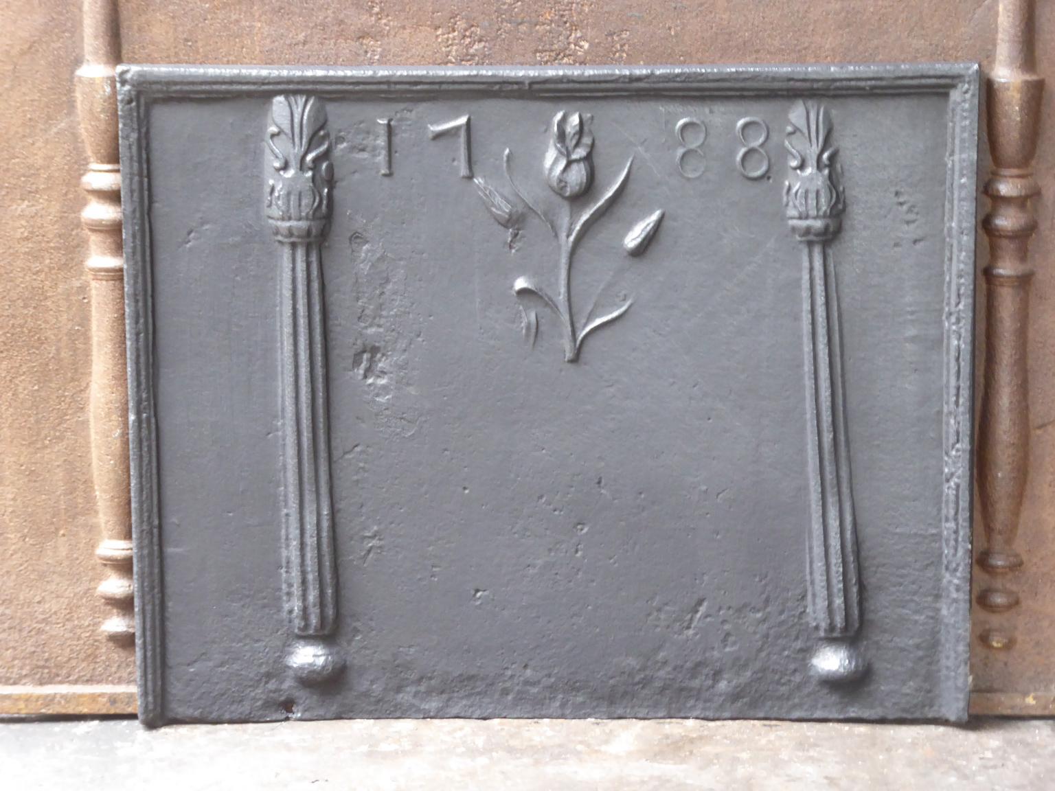 French neoclassical fireback with two decorated pillars, a flower and the date of production 1788.

The fireback is made of cast iron and has a black / pewter patina. It is in a good condition and does not have cracks.