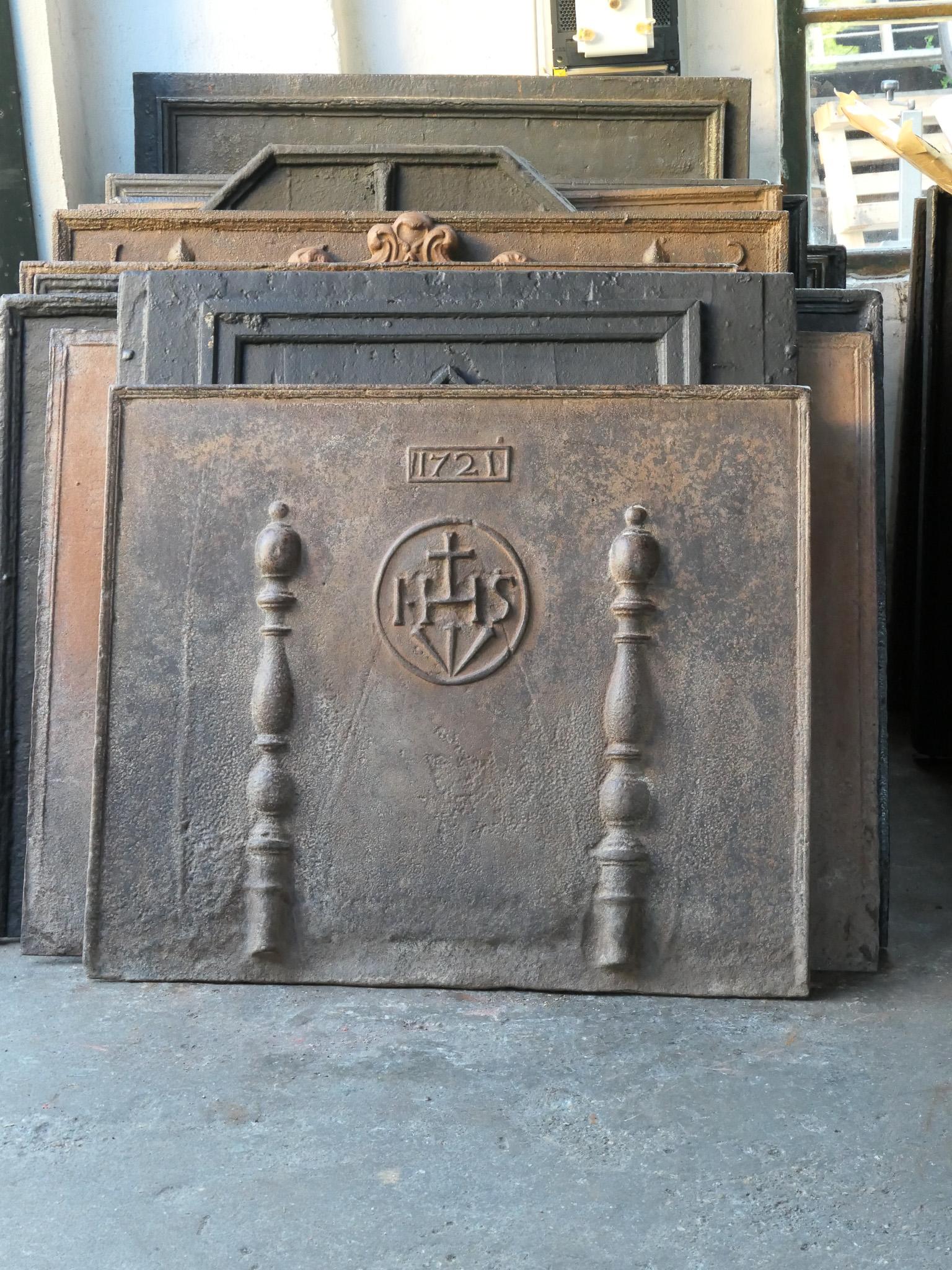 18th century French Louis XIV fireback with two pillars, a IHS monogram and the date of production 1721.

The monogram IHS stands for Iesus Hominum Salvator (Jesus the Savior of Humanity) or In Hoc Signo (In this sign will you win). The pillars