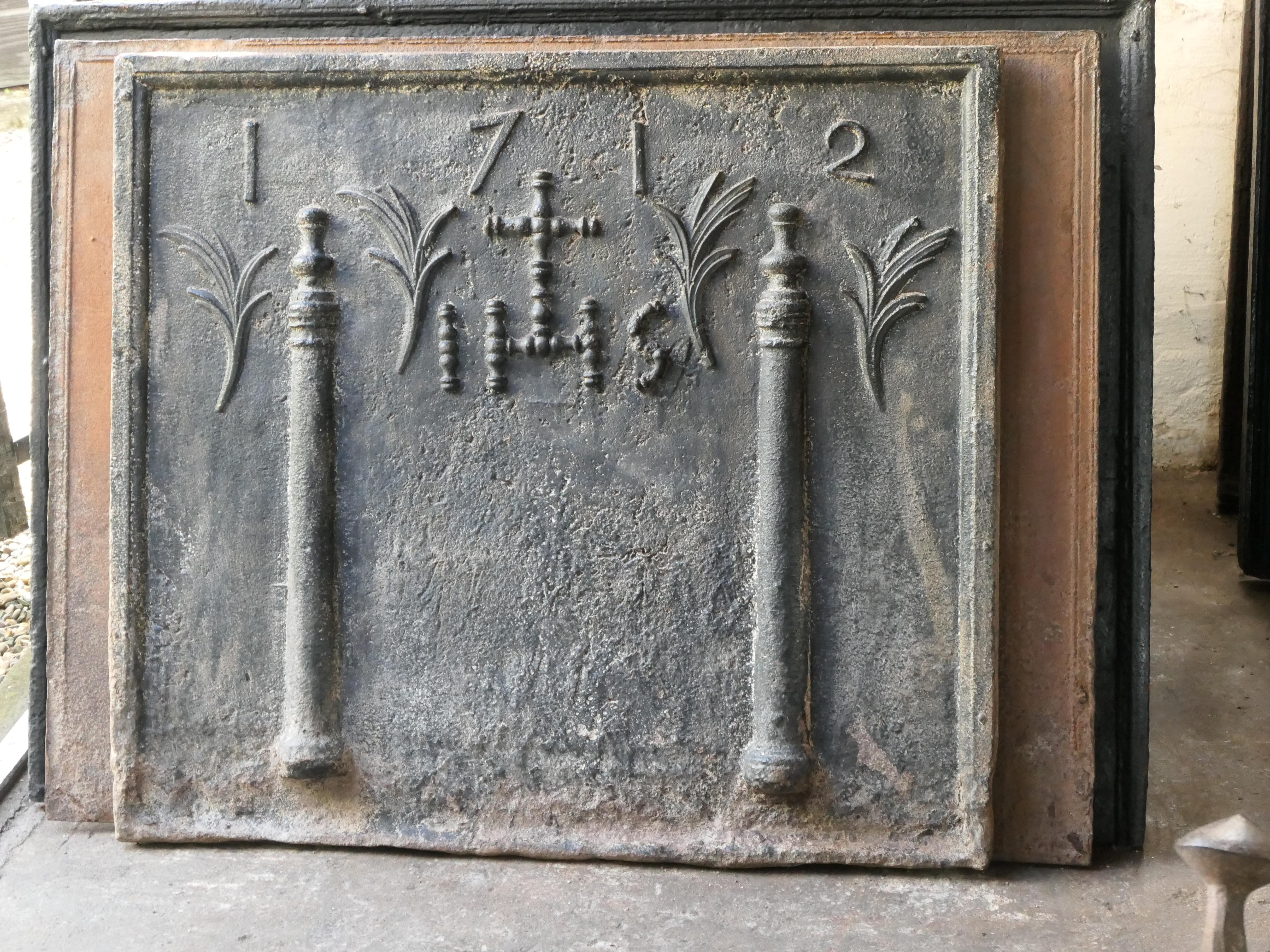 18th century French Louis XIV fireback with two pillars, a IHS monogram and the date of production 1712.

The monogram IHS stands for Iesus Hominum Salvator (Jesus the Savior of Humanity) or In Hoc Signo (In this sign will you win). The pillars