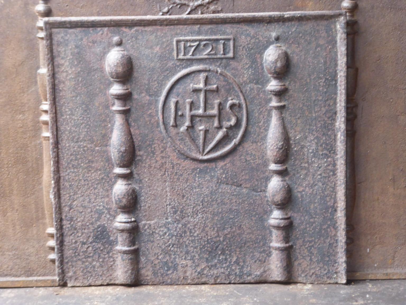 18th century French Louis XV fireback with two pillars, an IHS monogram, and the date of production 1721.

The monogram IHS stands for Iesus Hominum Salvator (Jesus the Savior of Humanity) or In Hoc Signo (In this sign will you win). The pillars