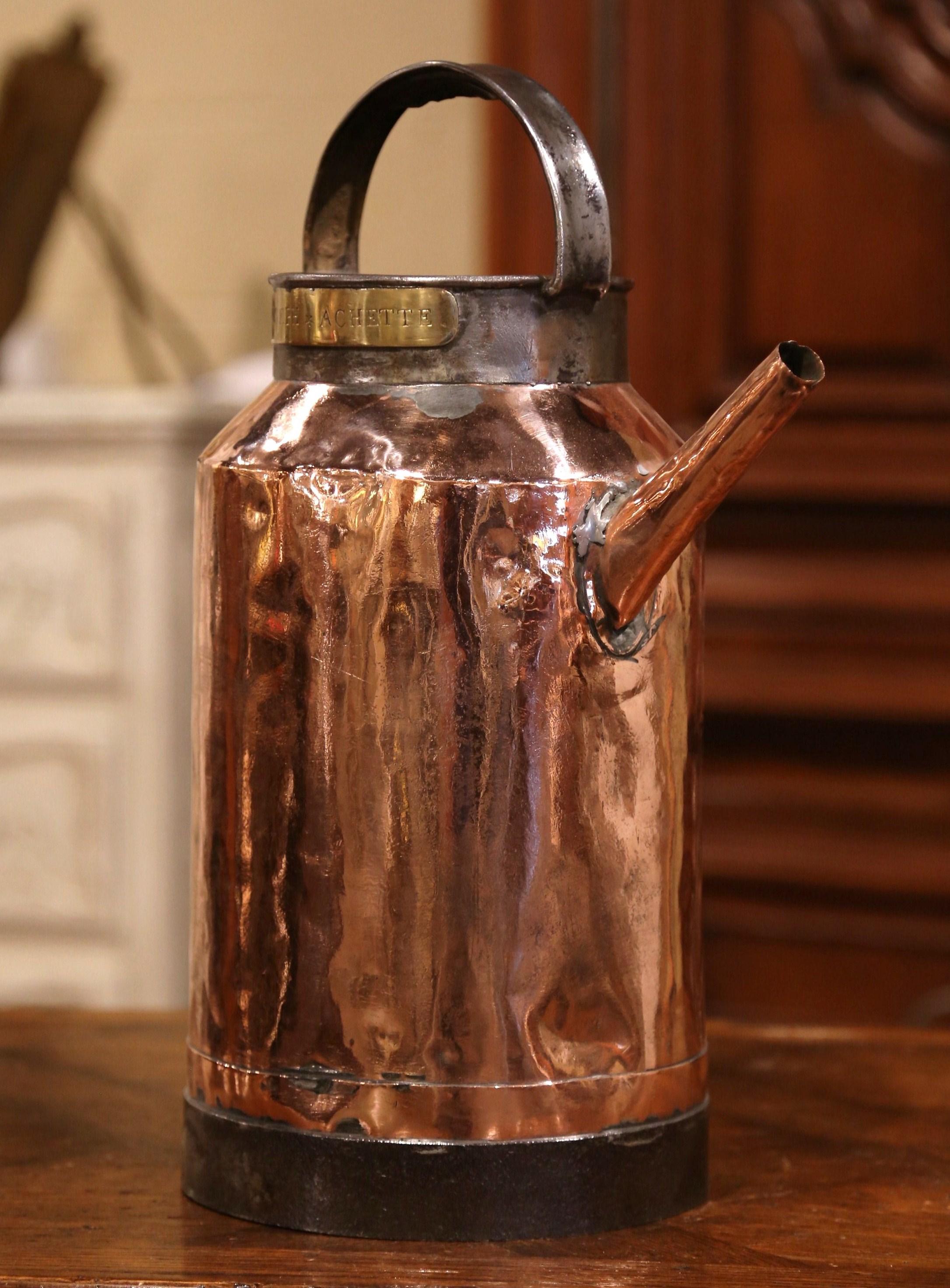 Water your plants elegantly with this antique copper and iron watering can, crafted in France, circa 1780, the can stands on a forged iron round base, the water piece features a top and a side handles, embellished with a pouring spout. It is further