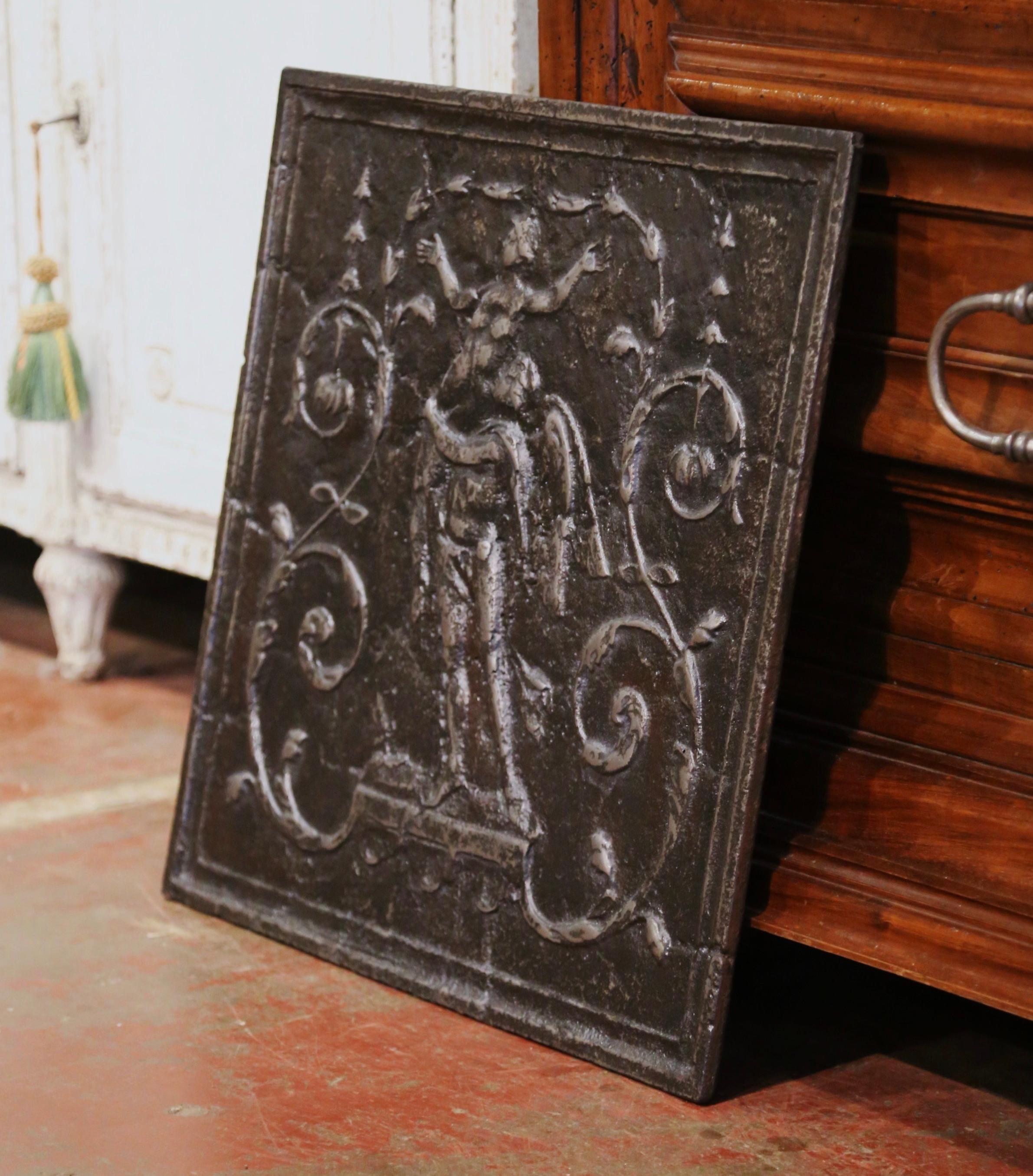 Decorate a fireplace hearth with this elegant antique fire back, created in France circa 1760, and square in shape, the plaque features a Roman allegoric scene with a male male angel holding a woman in his arms. The plaque is further embellished