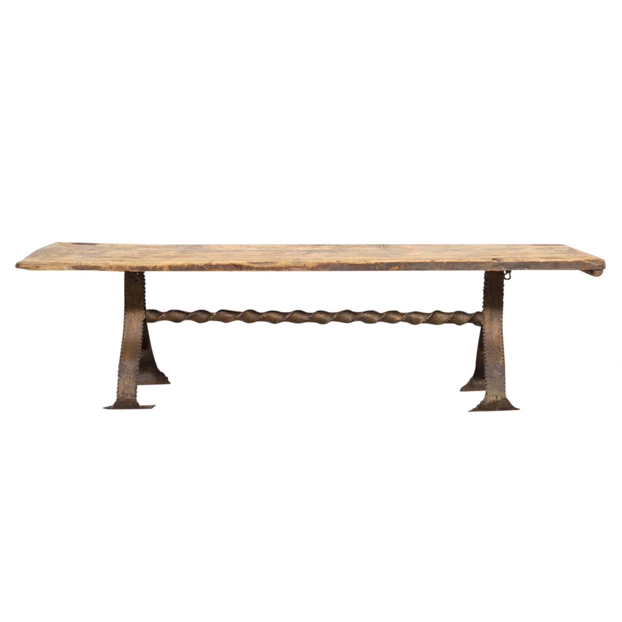 Handsome 18th century French bench handcrafted of pine and iron in the walled Breton town of Dinan in northwest France, circa 1770s. This versatile primitive bench has a wonderful sun bleached patina and features a two plank top resting on an iron