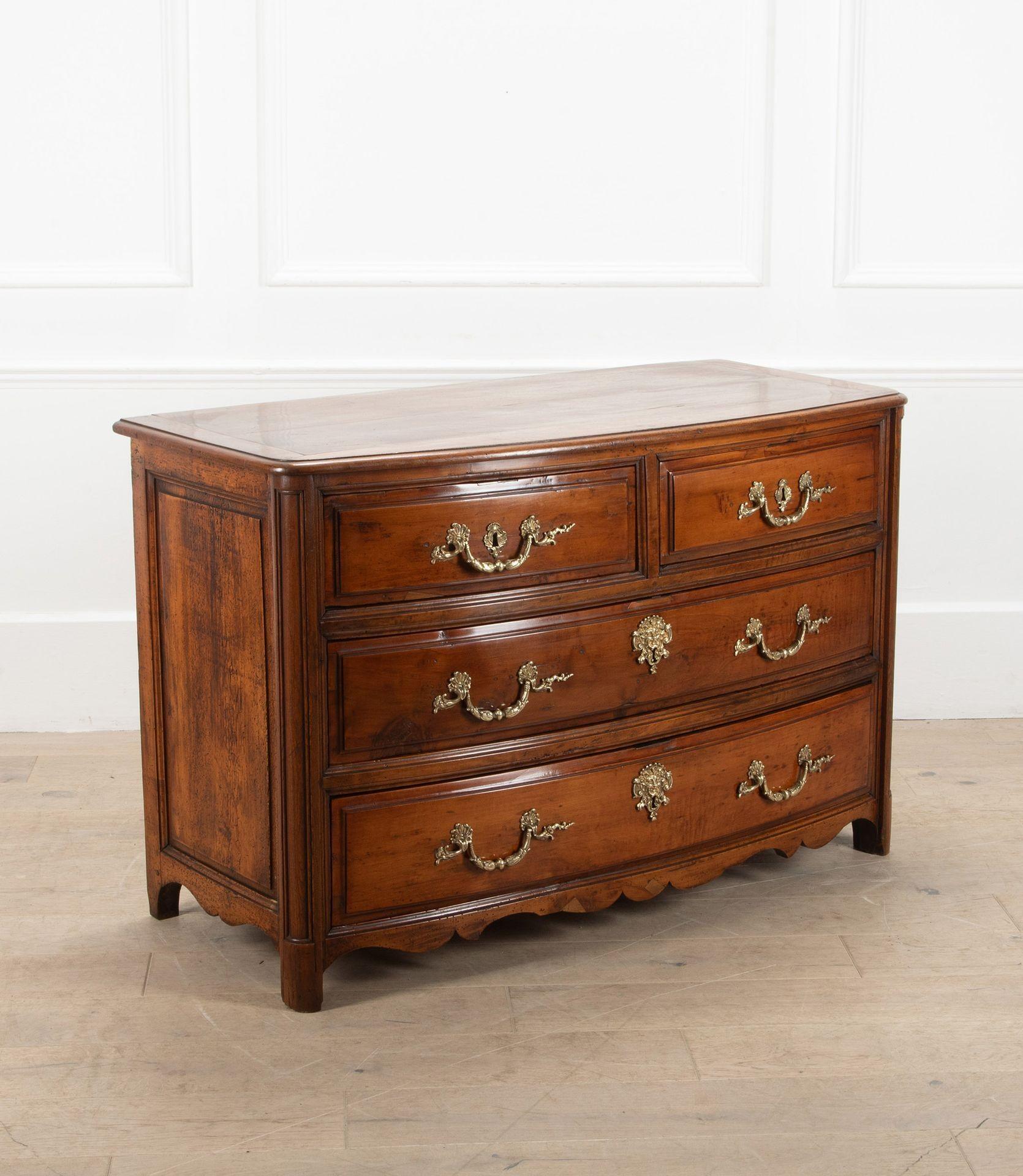 A lovely 18th Century French Provençal bow front commode.
Made from a charming mix of walnut, elm and cherry. With two short drawers over two long ones. 
A rich colour and patina along with antique handles enhance this piece.
