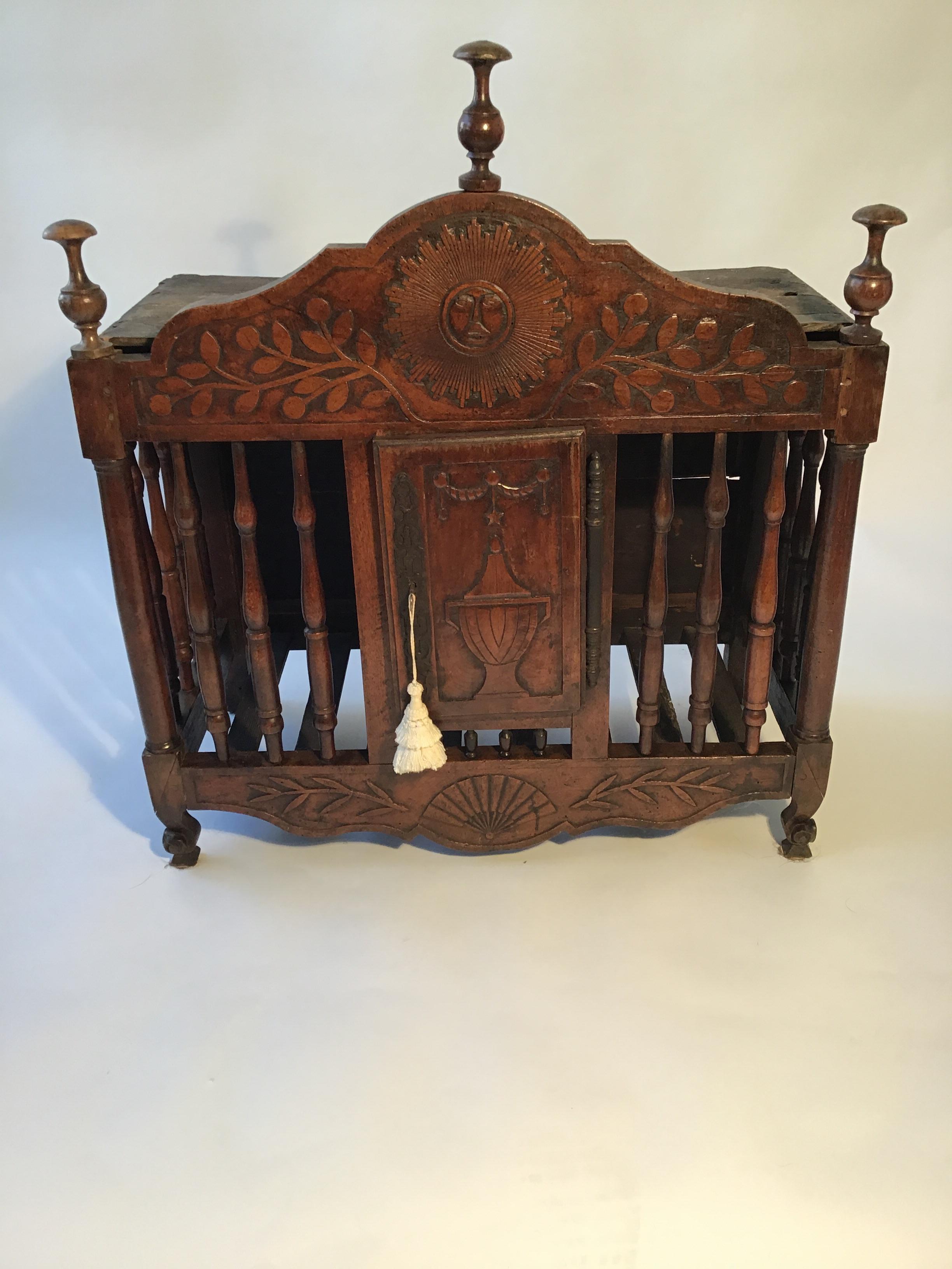 This 18th century hand carved walnut panetiere was created in the finest detail, showing off it’s beautiful face of the sun, and urn door. Originally used to store French Baguettes or long loaves of bread in French manor homes, panetierres were