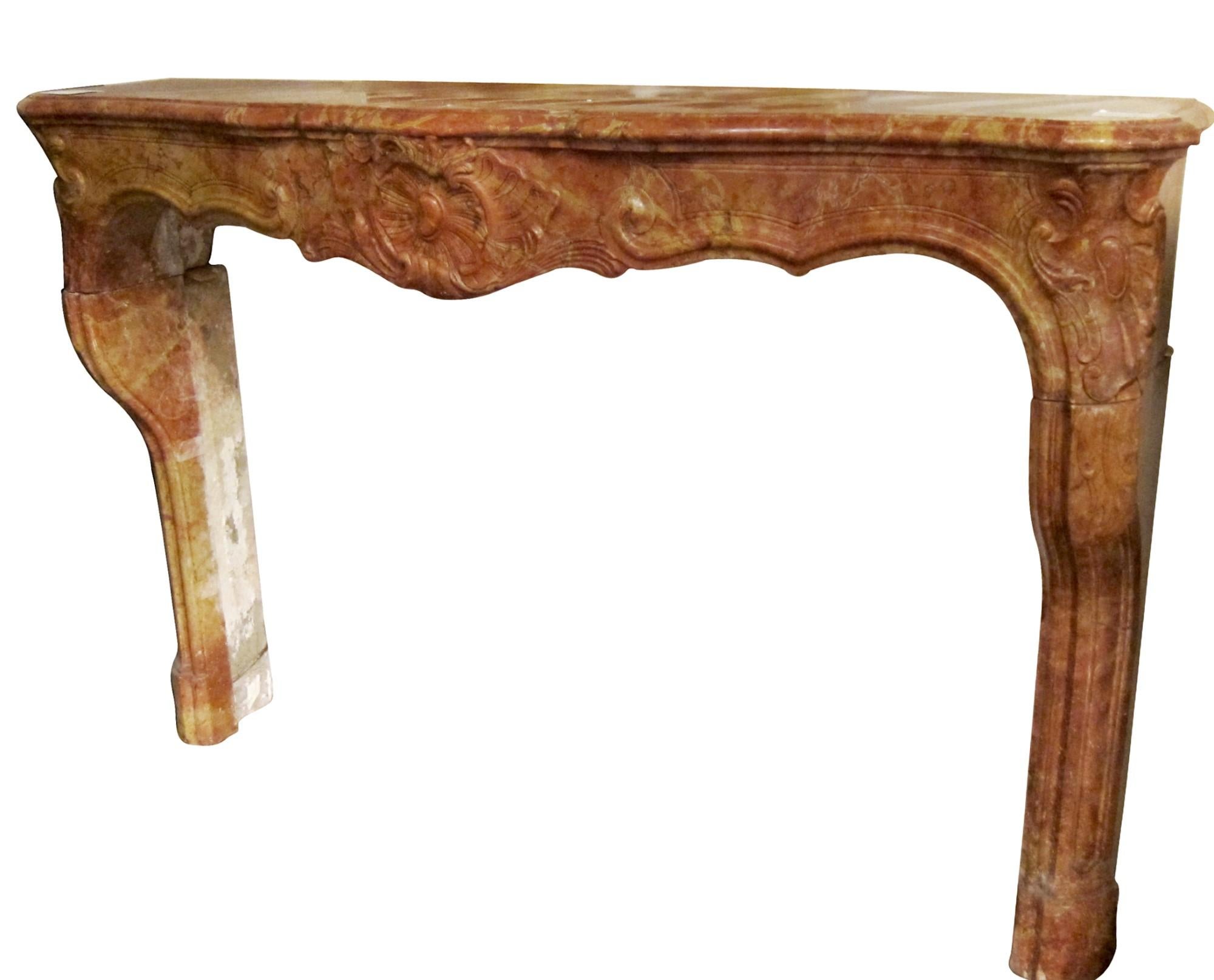 Circa 18th Century carved marble mantel from France. This stone mantel has a country feel and features burgundy and reddish orange coloring with caramel veining. Please note, this item is located in our Scranton, PA location.
 