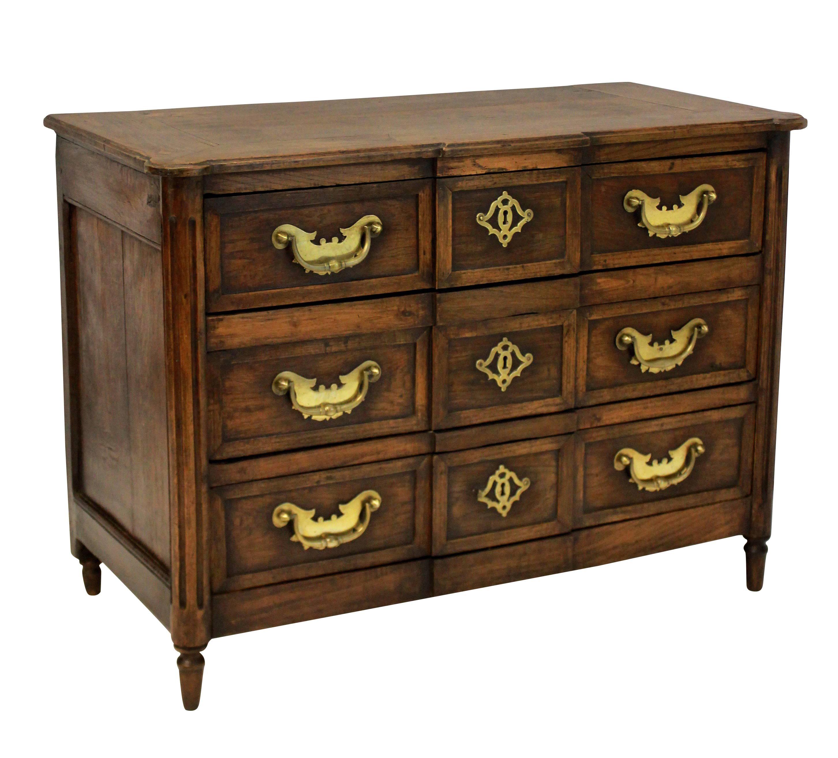 A French Provincial commode in oak, with beautiful brass handles and escutcheons.

