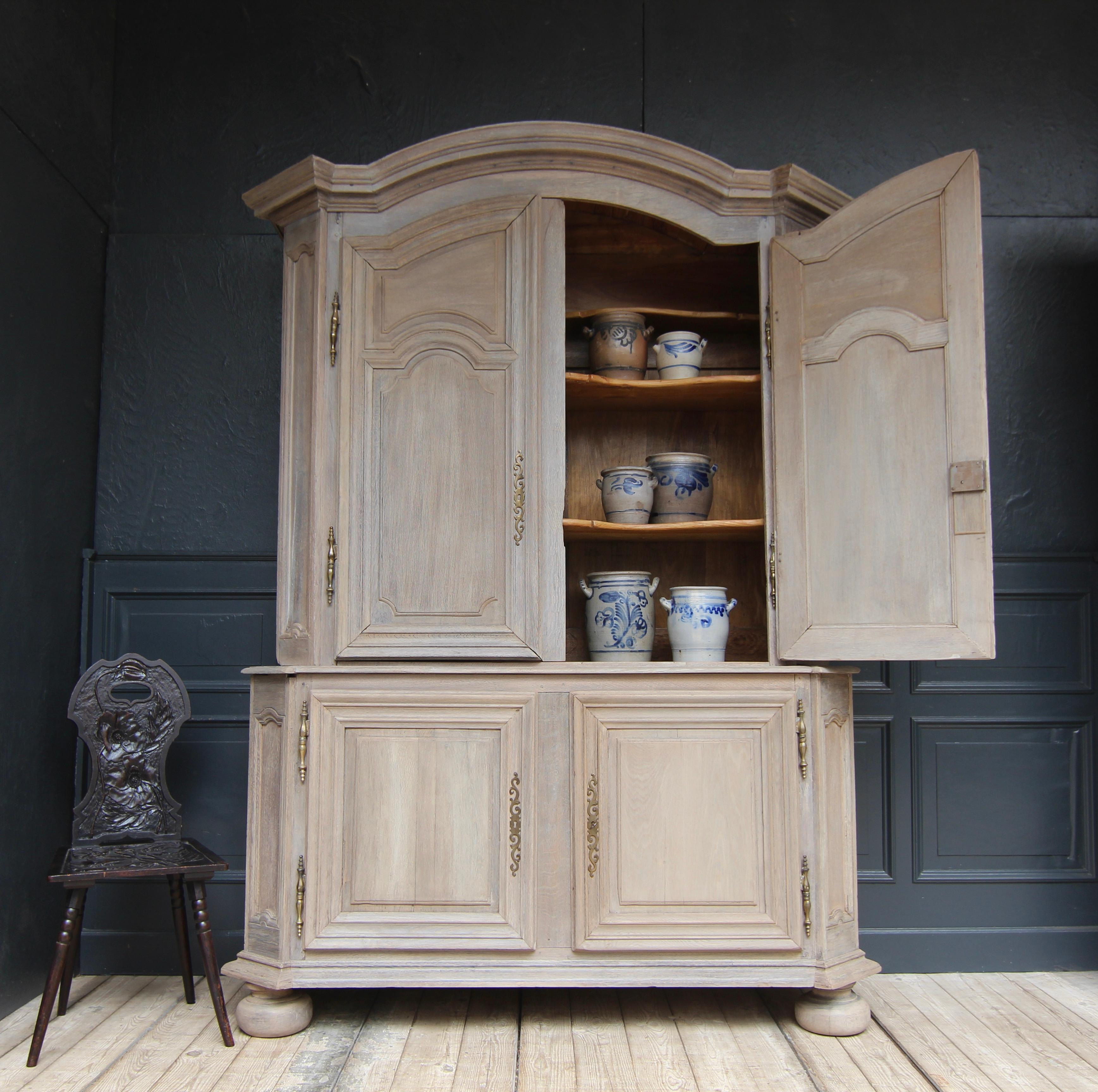 A 18th century French provincial Louis XIV buffet à deux corps. Probably from Alsace. Made of solid oak with new patina finish.

Two-part, laterally coffered oak body with bevelled pilaster strips and 4 doors made in frame- and panell- construction
