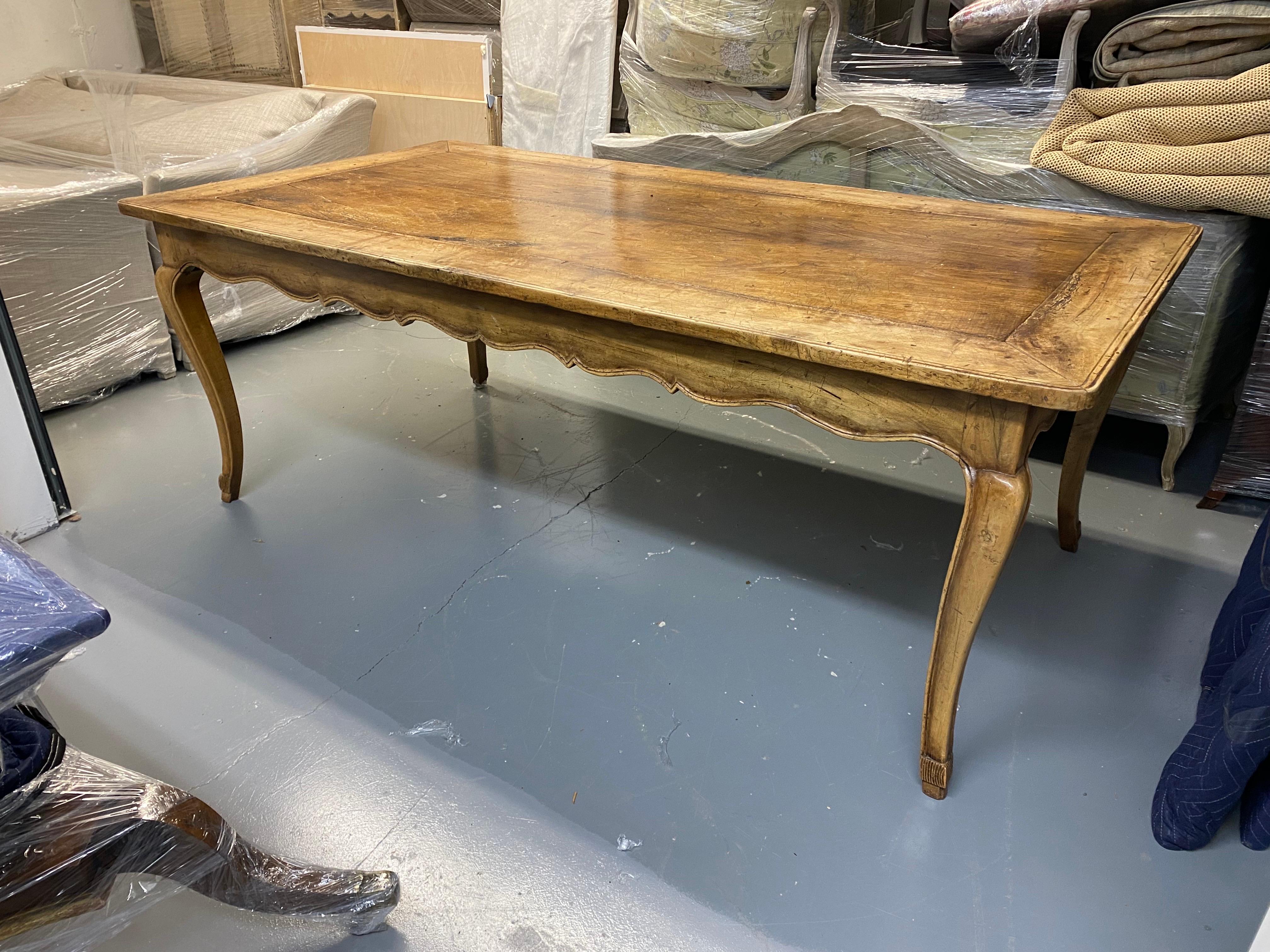 18th Century French Provincial Cherrywood & Oak Dining Table
A lovely worn patina French farm table. Center boards in oak, frame in cherrywood. 18th Century. Undulating apron, cabriole legs, peg joinery. General wear throughout consistent with age