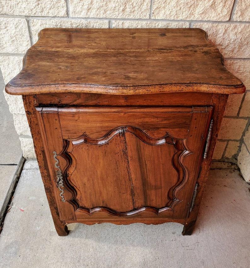 A charming Provincial Louis XV period confiturier with beautifully aged rich patina.

Hand-crafted of solid fruitwood, likely cherry-wood case and a thick walnut slab top with front and side serpentine shaped molded edge, over a rectangular solid