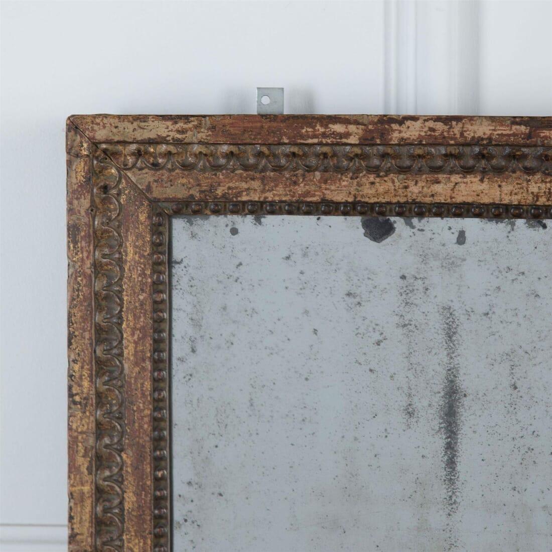 A beautifully faded late 18th century carved mirror, France, circa 1790.