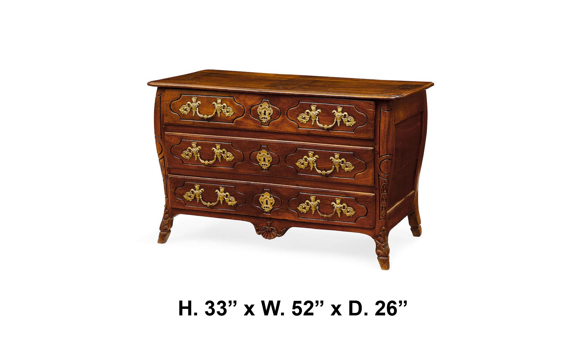 18th century French provincial Regence finely carved walnut three-drawer commode mounted with intricate gilt bronze handles, all on hoof feet.