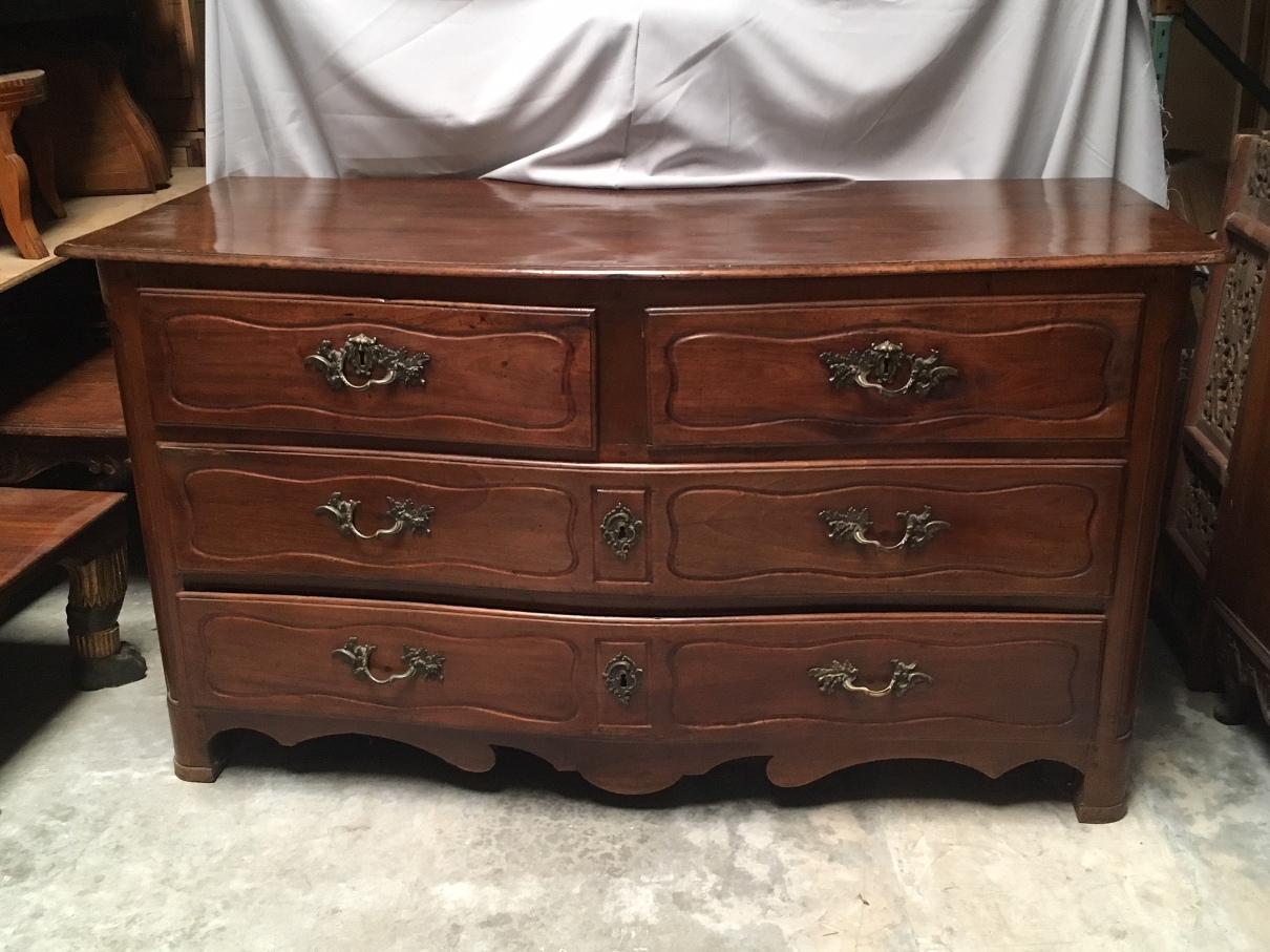 Oversized 18th century French Provincial walnut wider commode. Wooden rectangular top over two short drawers and two long drawers with fine bronze-mounted handles in a foliage motif, all resting on four block feet.