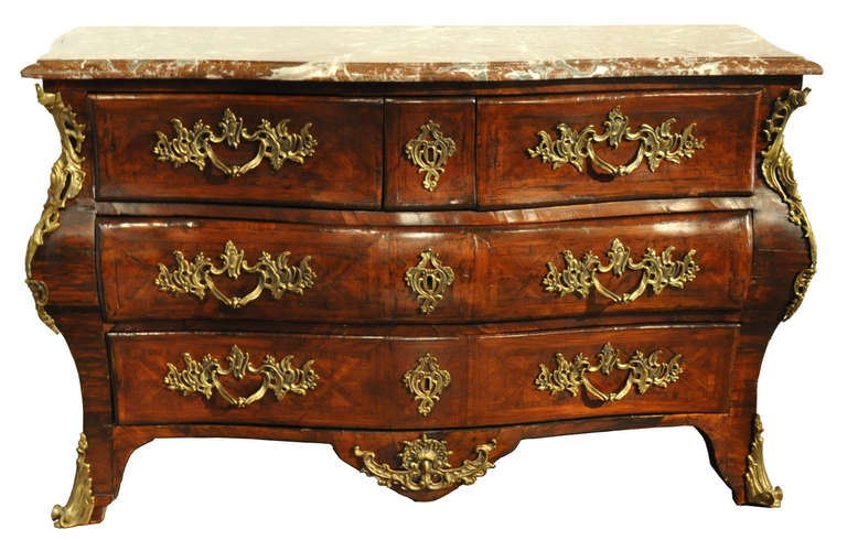 Decorate your living with this elegant Louis XV fruitwood commode with marble top, crafted in Paris, France, circa 1750, the antique chest sits on scroll feet over a scalloped apron and features four bombe drawers across the front with intricate