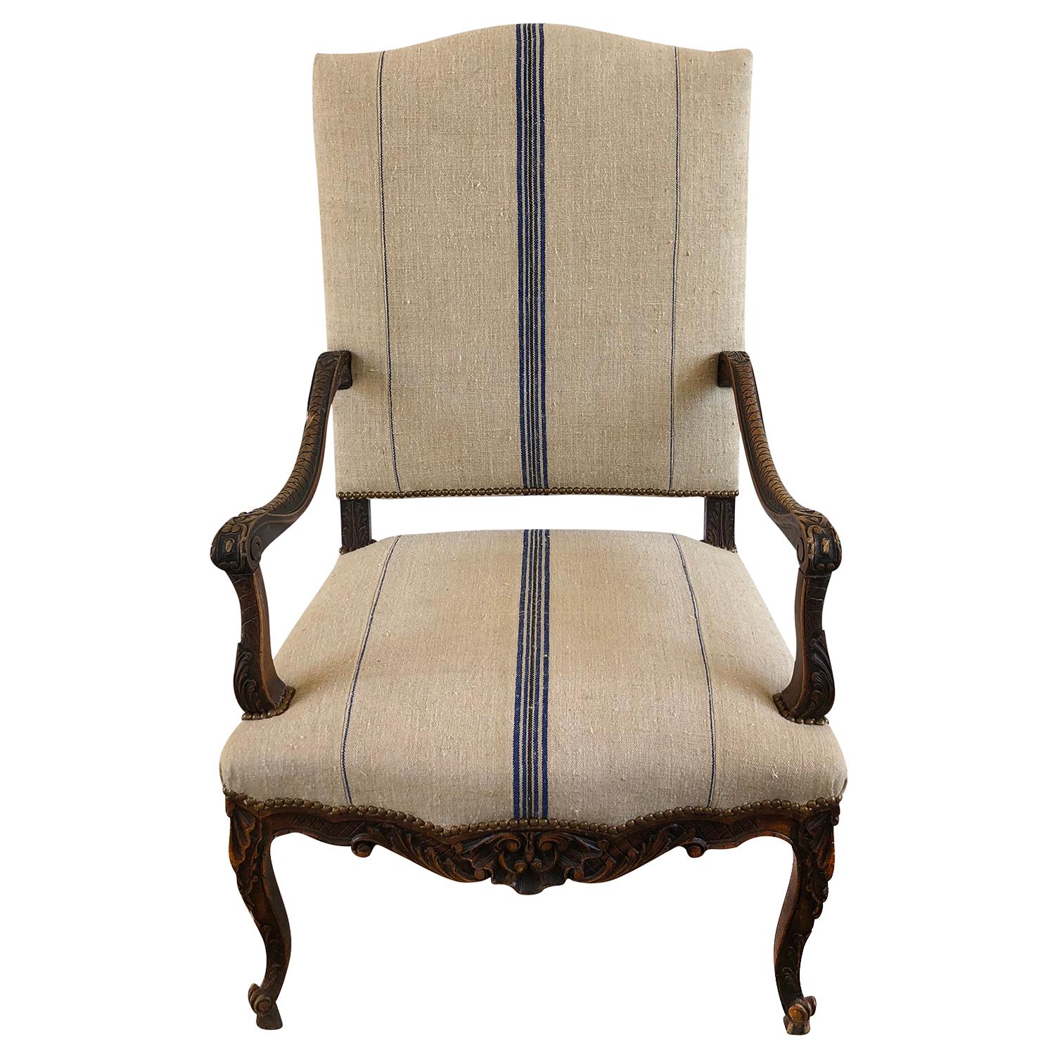 An antique French armchair from Bourgogne, France. A hand crafted Beechwood frame and brass detailing in good condition. Centered blue and black striped hemp fabric and matching small pillow. Wear consistent with age and use, circa 18th century,