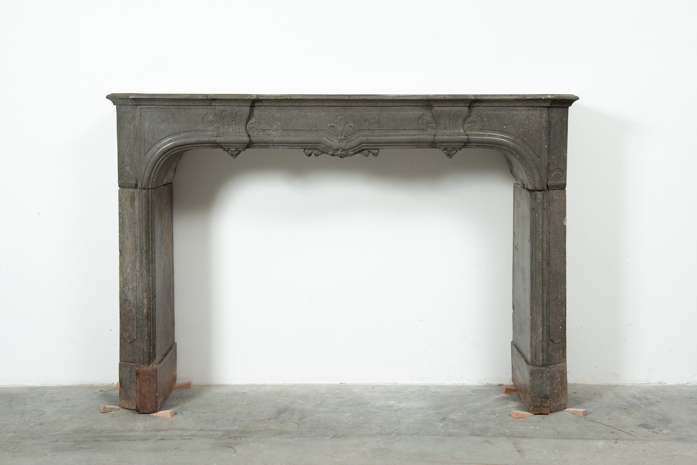 18th Century French Régence Style Fireplace Mantel in Buxy Limestone

This exquisite 18th Century Régence style fireplace mantel originates from France and is carved from the coveted Buxy limestone, known for its deep, smoky grey tones and