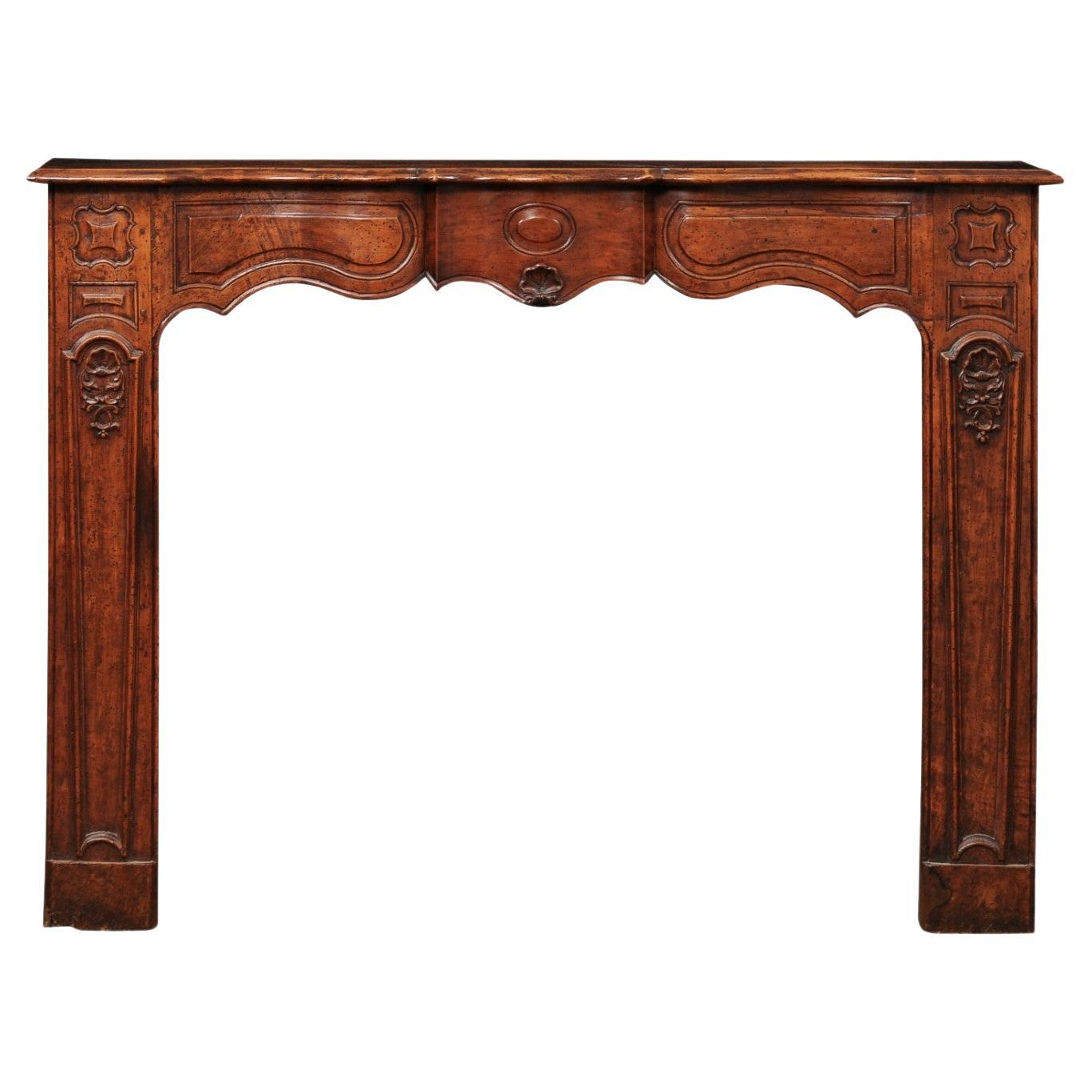 18th Century French Regence Style Walnut Mantle with Shell Carving For Sale