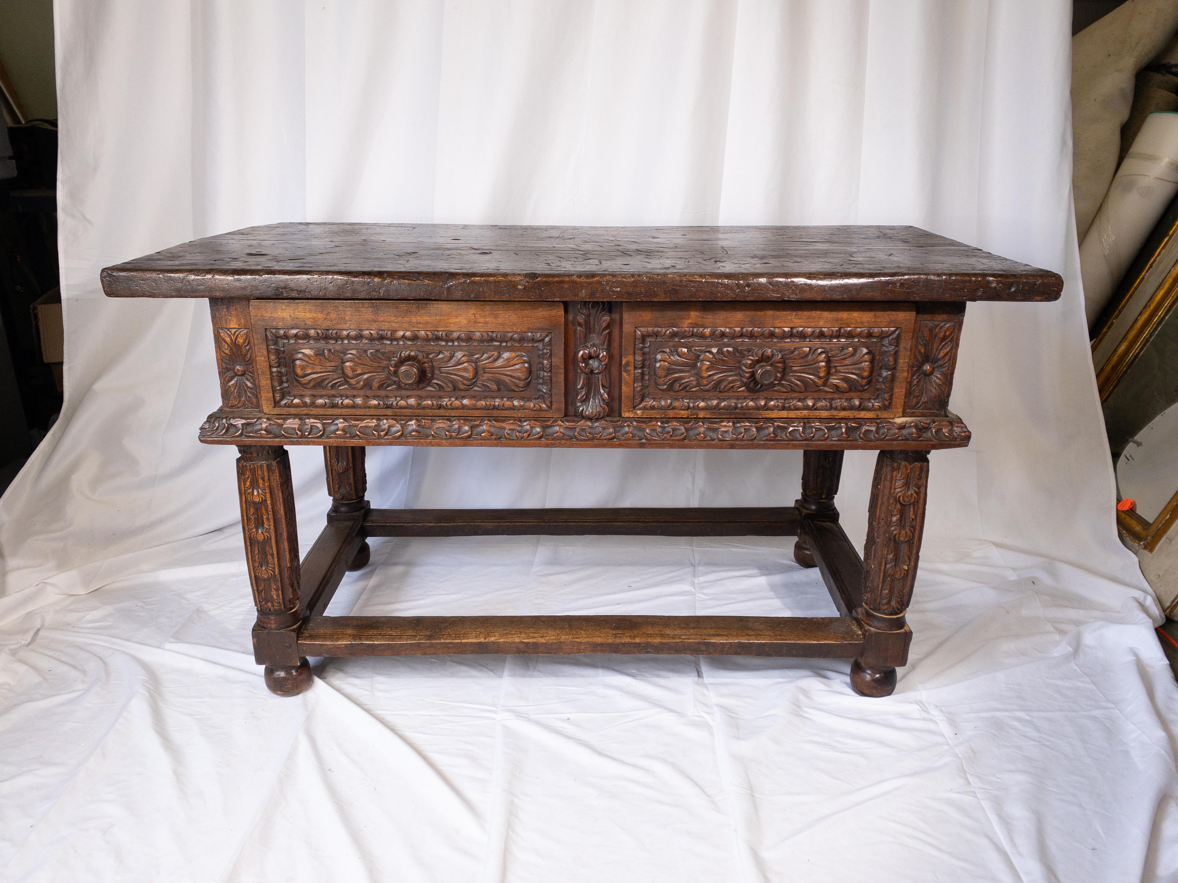 The 18th Century French Renaissance Console Table exudes elegance and opulence with its exquisite craftsmanship and lavish design. Crafted from rich, aged wood, its sturdy plank top provides a luxurious canvas for display or practical use. The