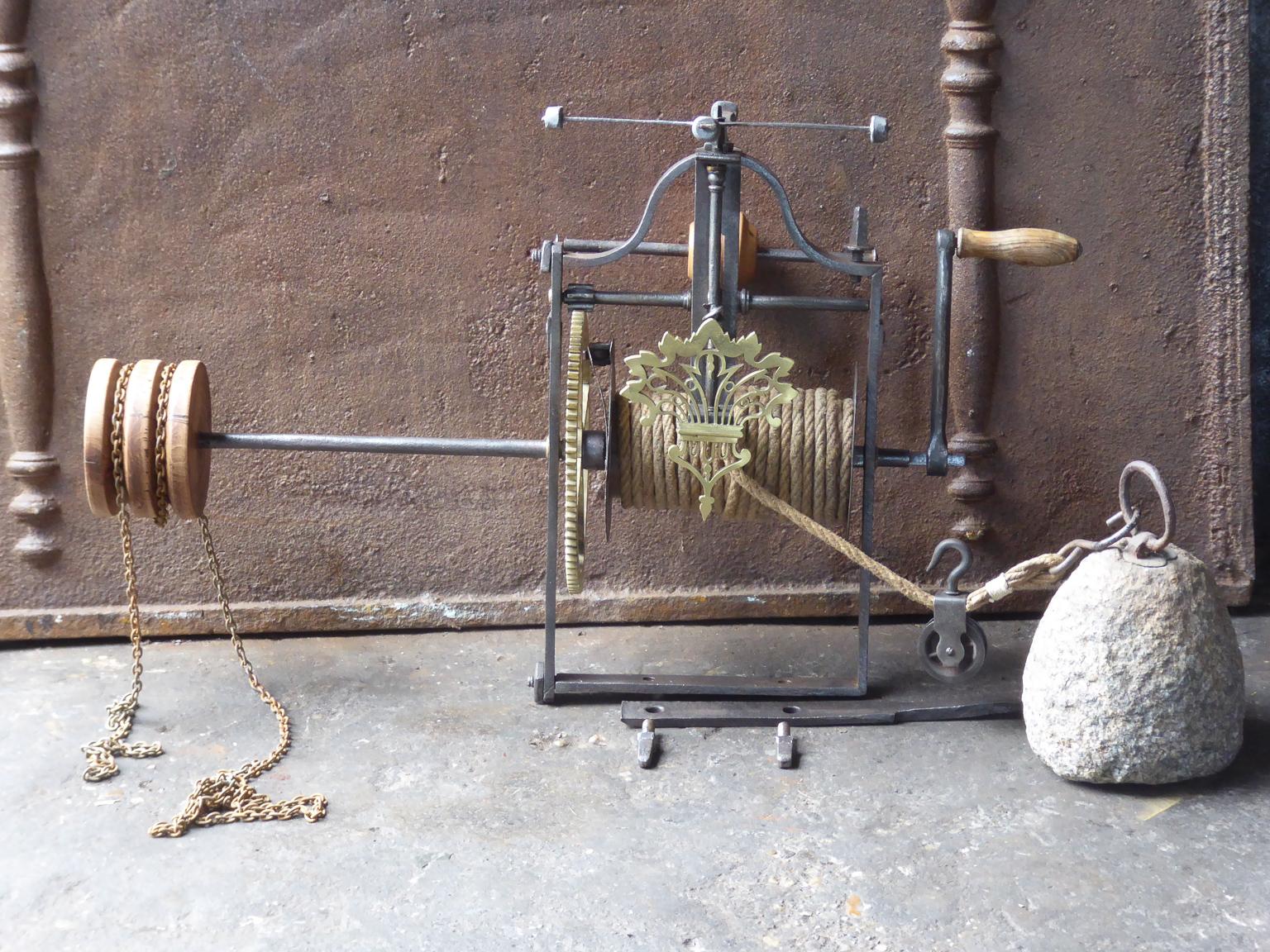 18th century French roasting jack made of wrought iron, wood and brass. The roasting jack can be used for cooking in the fireplace. It is fully functional. 







 