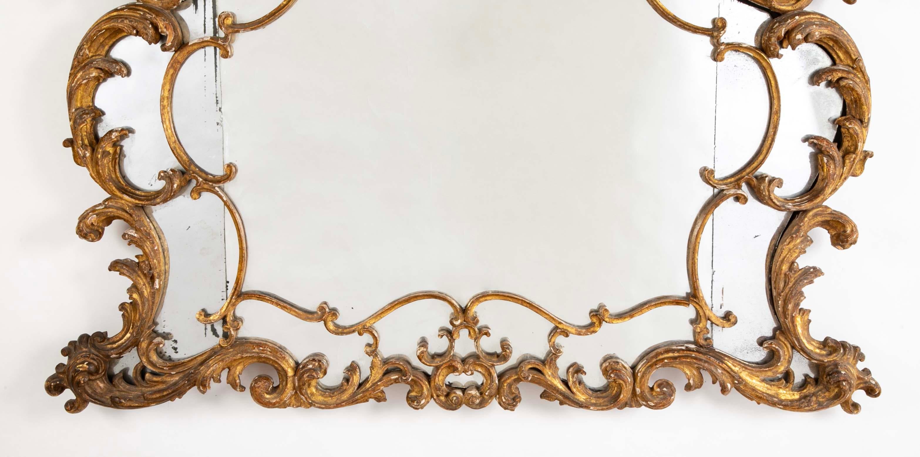 18th century French Rococo gilt wood over-mantle mirror with original glass and gilding. What a wonderful mirror this is, in original condition, carved in the Rococo style. The carving is both exuberant and refined. The glass is in three sections,