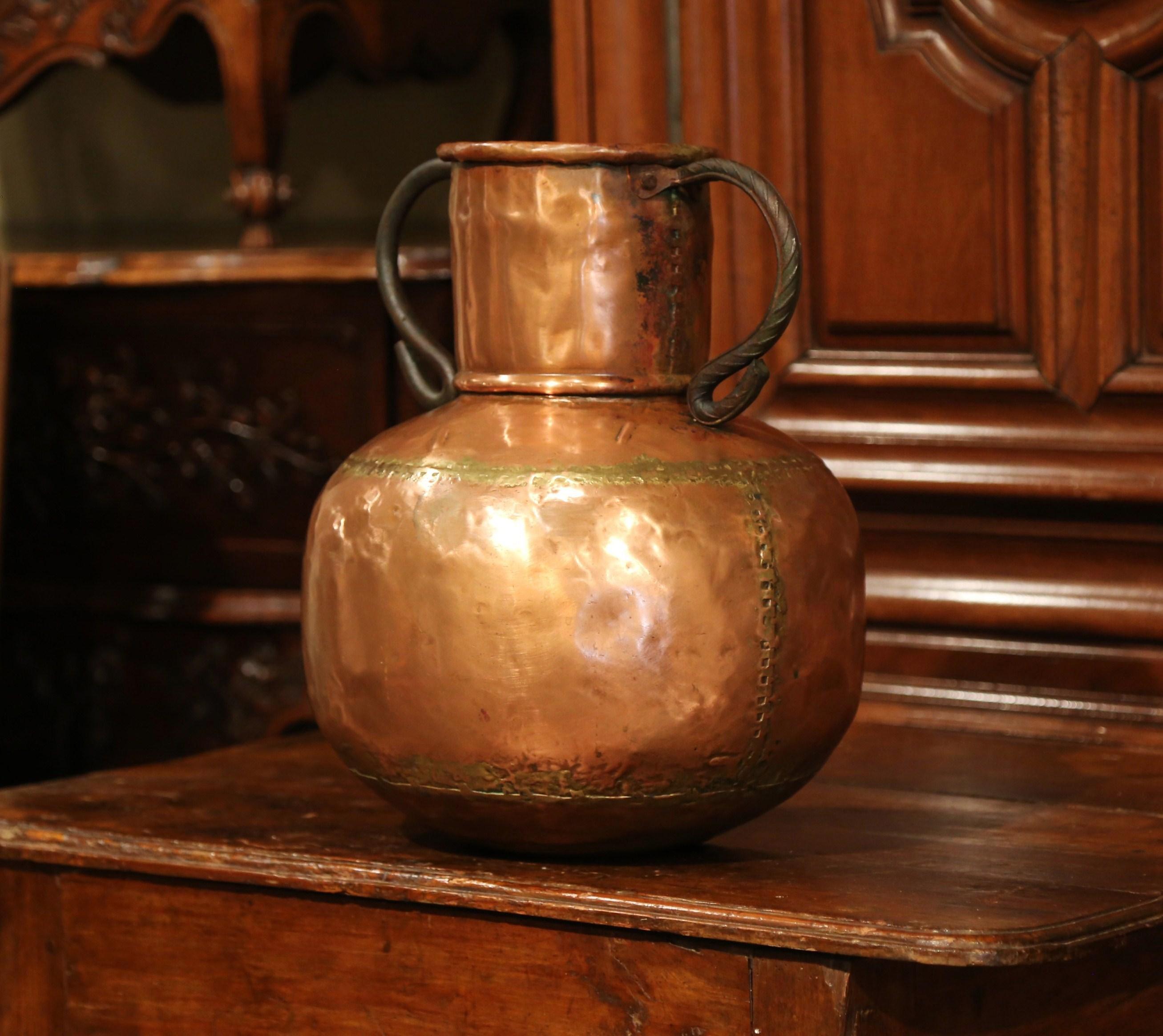 This large, copper vase is a French country essential. Wide, durable and traditional in shape, this copper pot could be used as an umbrella stand, or as a vase to hold dried flowers. Crafted in France circa 1780, the antique vase has a long, tall