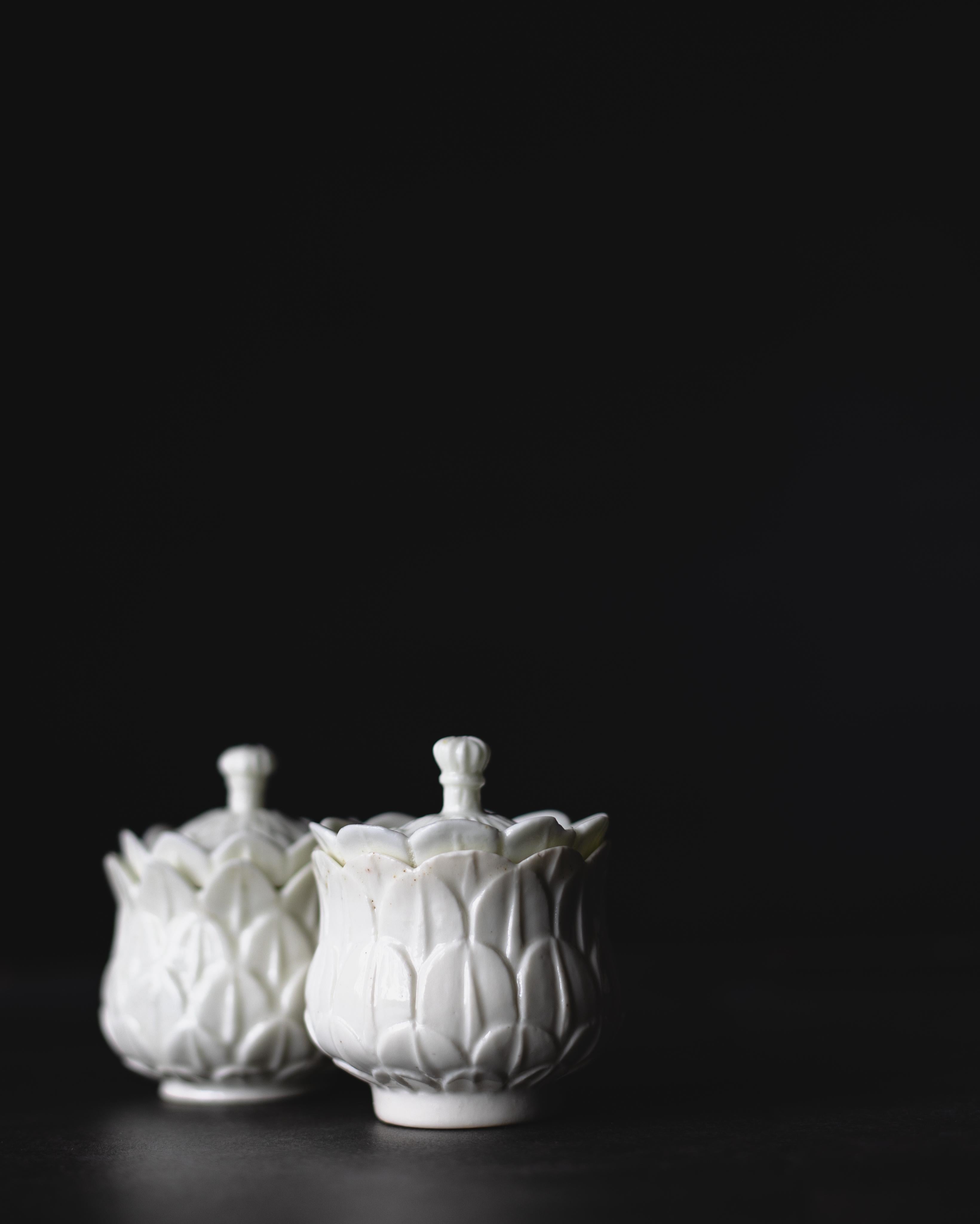 A near pair of soft-paste porcelain pots de crème, made by the French porcelain factory Saint-Cloud circa 1730-1740.

Saint-Cloud’s pure white porcelain valued the quality and beauty of a material which the West had long sought to reproduce. In