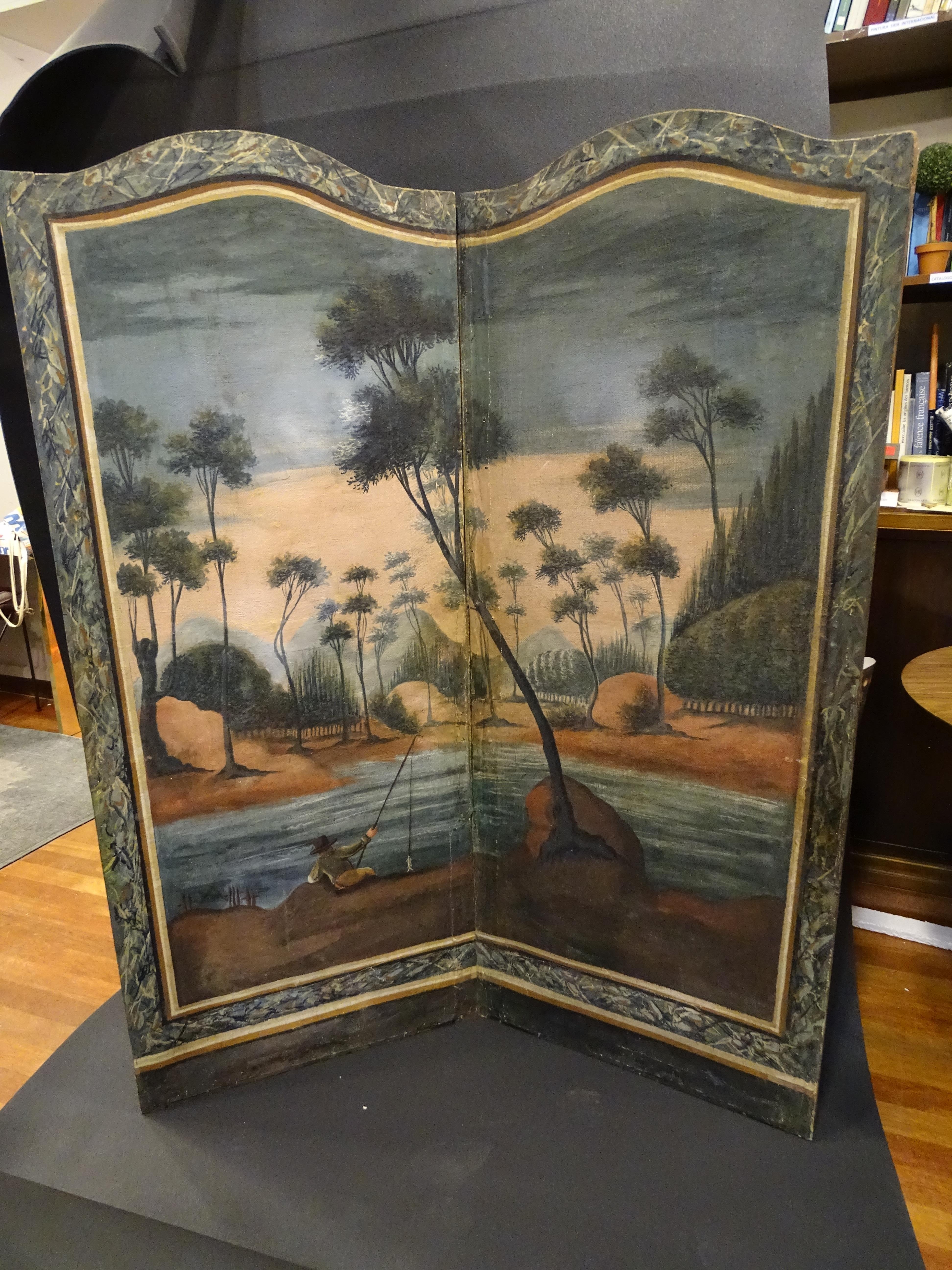 Outstanding two-leaf screen composed of two oil paintings on canvas framed in stuccoed wood. 18th century, France.
Acquired from a private collection in Uzes, southern France.

Representation of a river landscape surrounded by pine trees, a