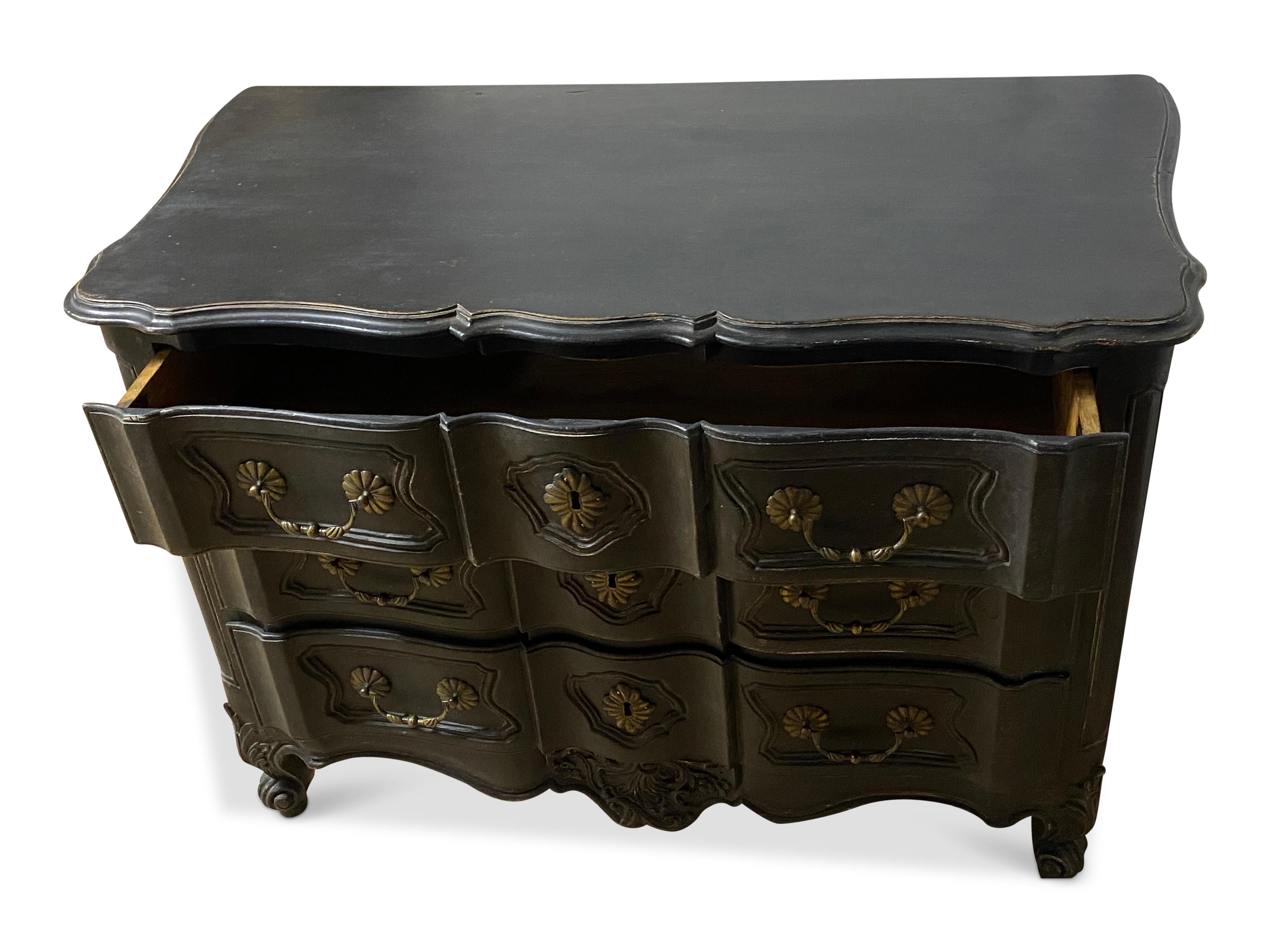 Wonderful 18th Century French serpentine commode with original handles.The later ebonised paintwork has given this piece a super contemporary look and an amazing storage solution.With scrolled feet and carvings and original brass ironwork  that