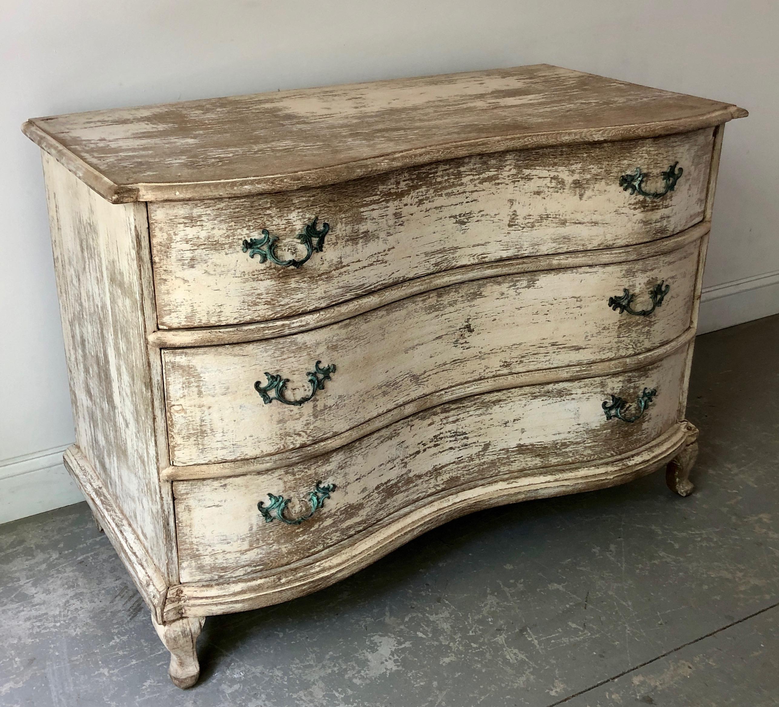 A handsome 18th century Serpentine front commode in trace of time worn paint with beautifully carved serpentine drawers resting on short cabriole feet. 
Alsace, France, circa 1770. 
Surprising pieces and objects, authentic, decorative and rare