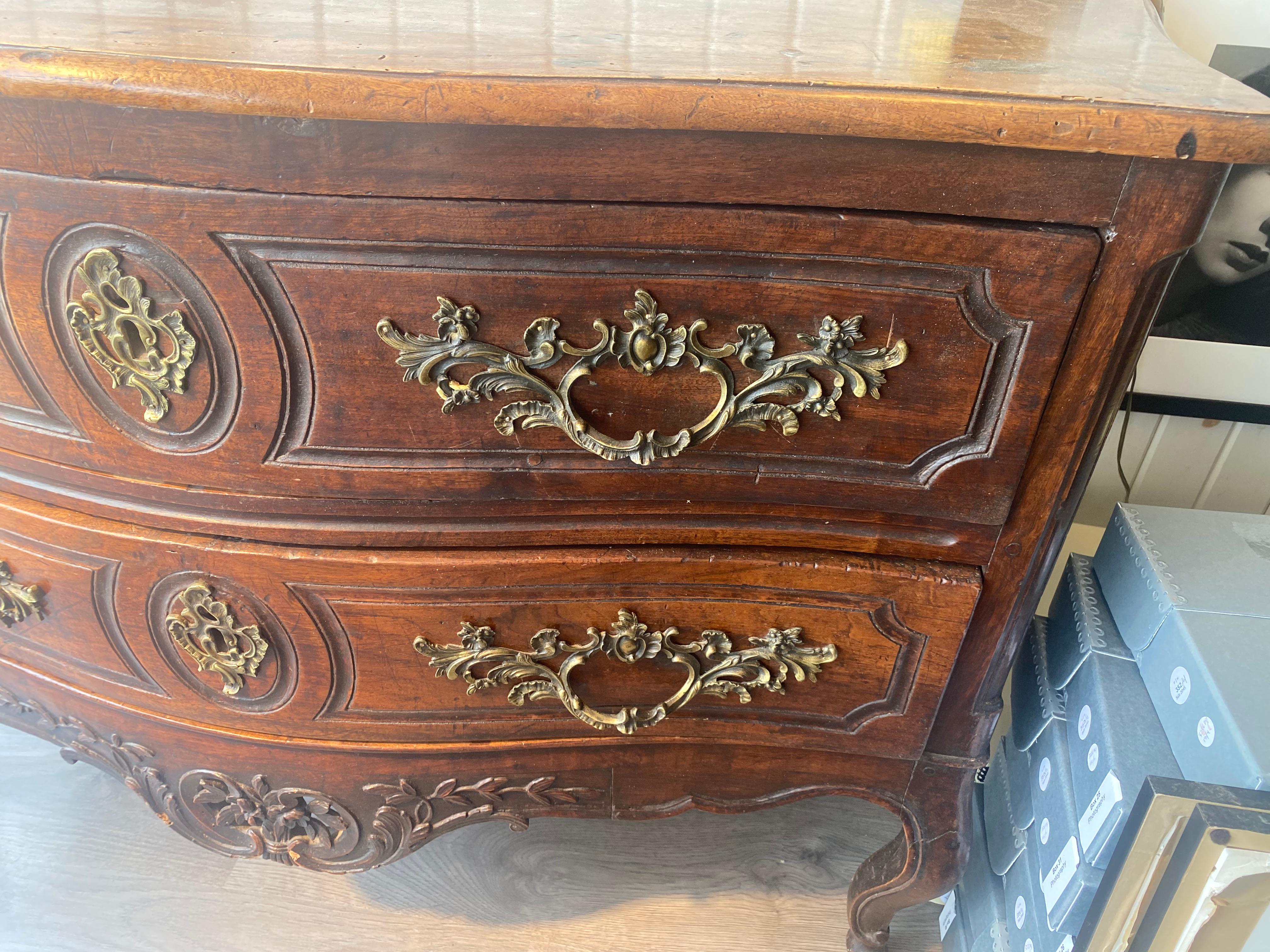 18th Century French serpentine front commode raised on legs with hooved feet, great color and patination.