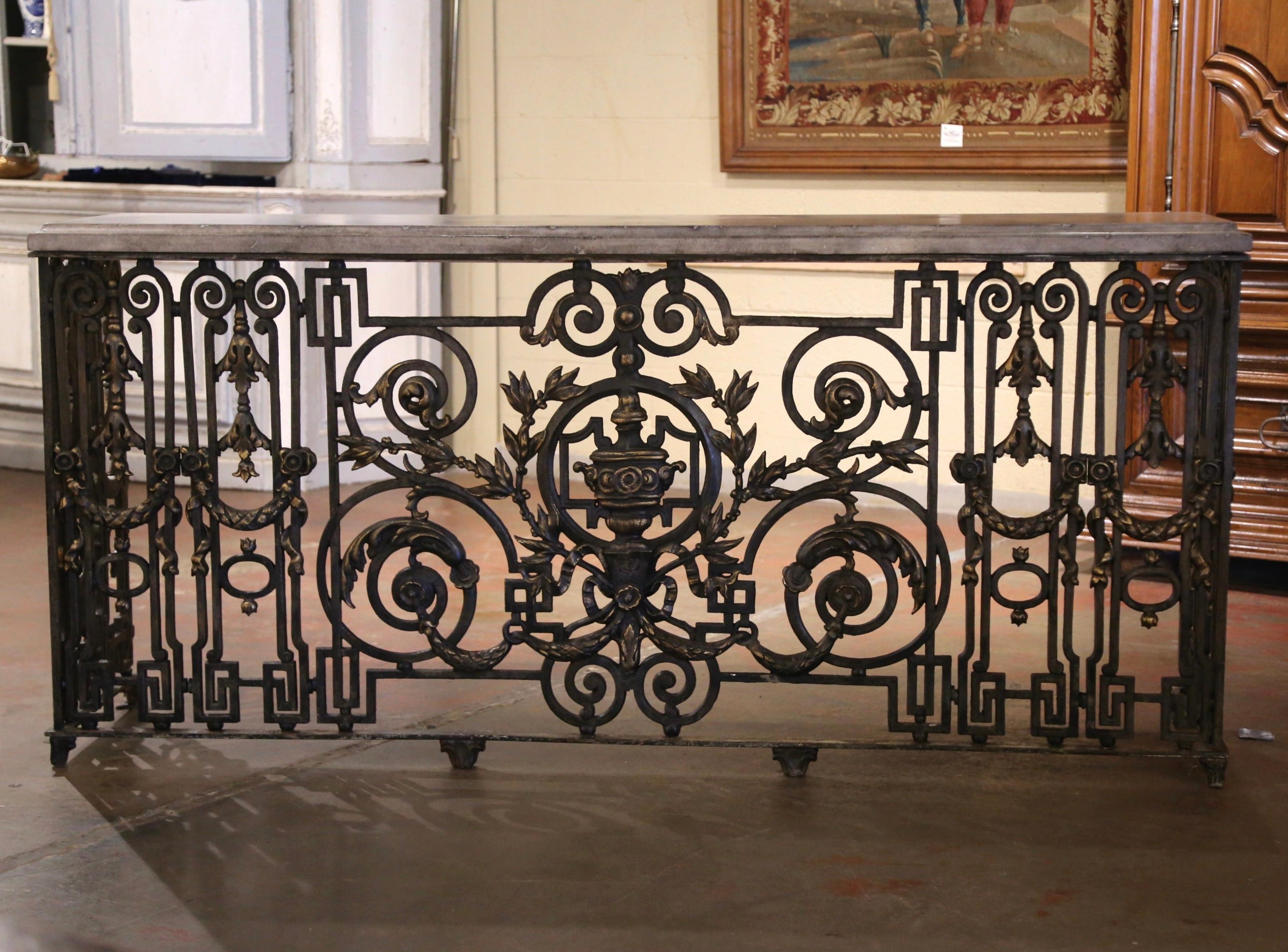 Forged in France circa 1770, and originated from a grand architectural structure, such as a staircase or balcony, this stunning antique wrought iron railing features a symmetrical arrangement of ornate scroll work, geometric patterns, and classical