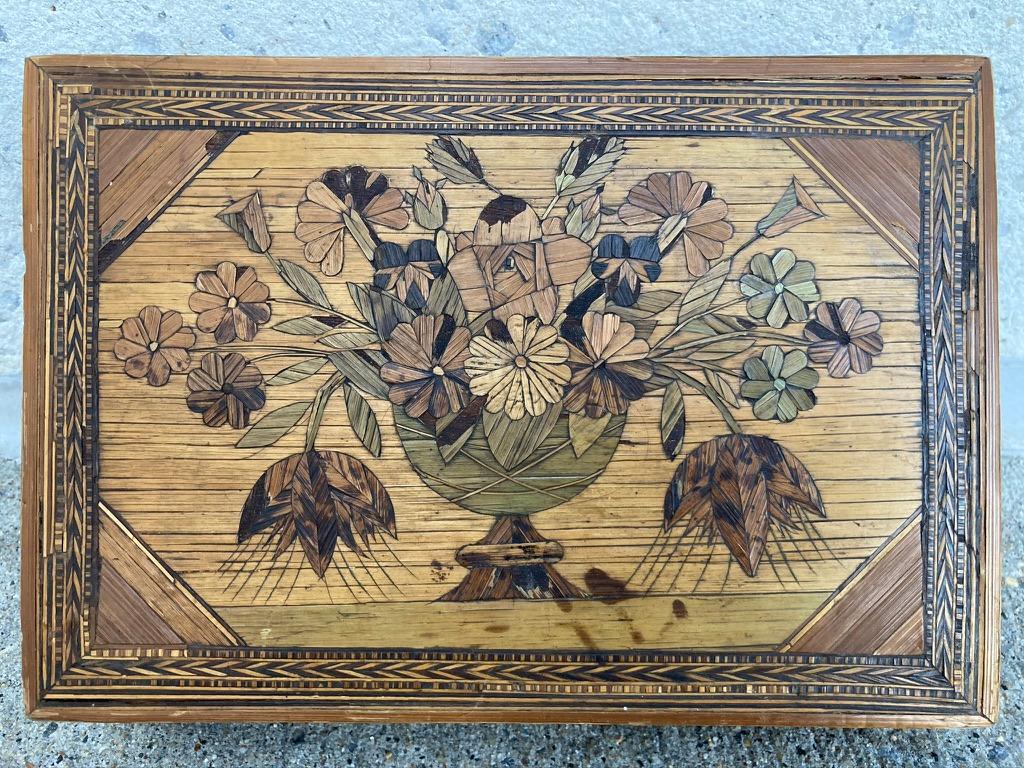 A beautiful late 18th or early 19th century example of 'Marqueterie de Paille', or straw marquetry, work box. The top inlaid with a vase and flowers, the interior retaining the vibrant original coloring, showing a building with towers flanked by two