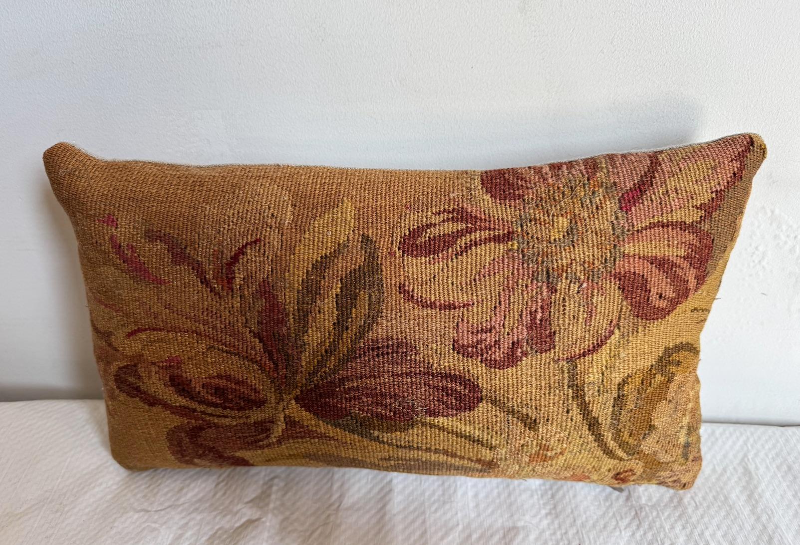 This pillow is made from an 18th-century French tapestry fragment, showcasing a beautifully aged floral motif, with a timeworn texture that brings authentic character and softness. An elegant accent for layered, eclectic, or classic interiors.