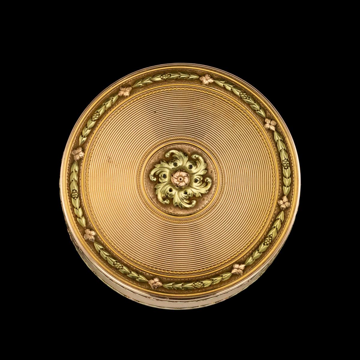 Antique 18th century French magnificent three-colored 18-karat gold snuff box / bonbonniere, of round form, engine turned decoration, the cover and base centred with vari-color gold rosette, edges chased with flowers and husk garlands on a matted