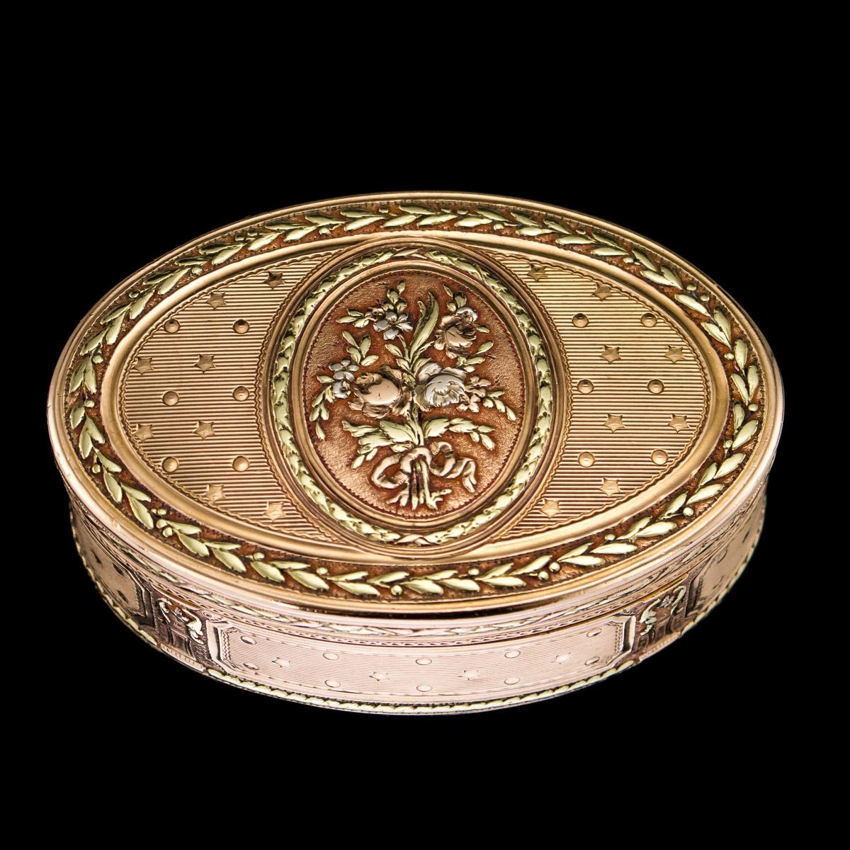 Antique 18th century French magnificent three-colored 18-karat gold snuff box, of oval form, engine turned, chased with floral decorations in oval reserves, within flowers and husk garlands on a matted ground.


Hallmarked with French hallmarks,