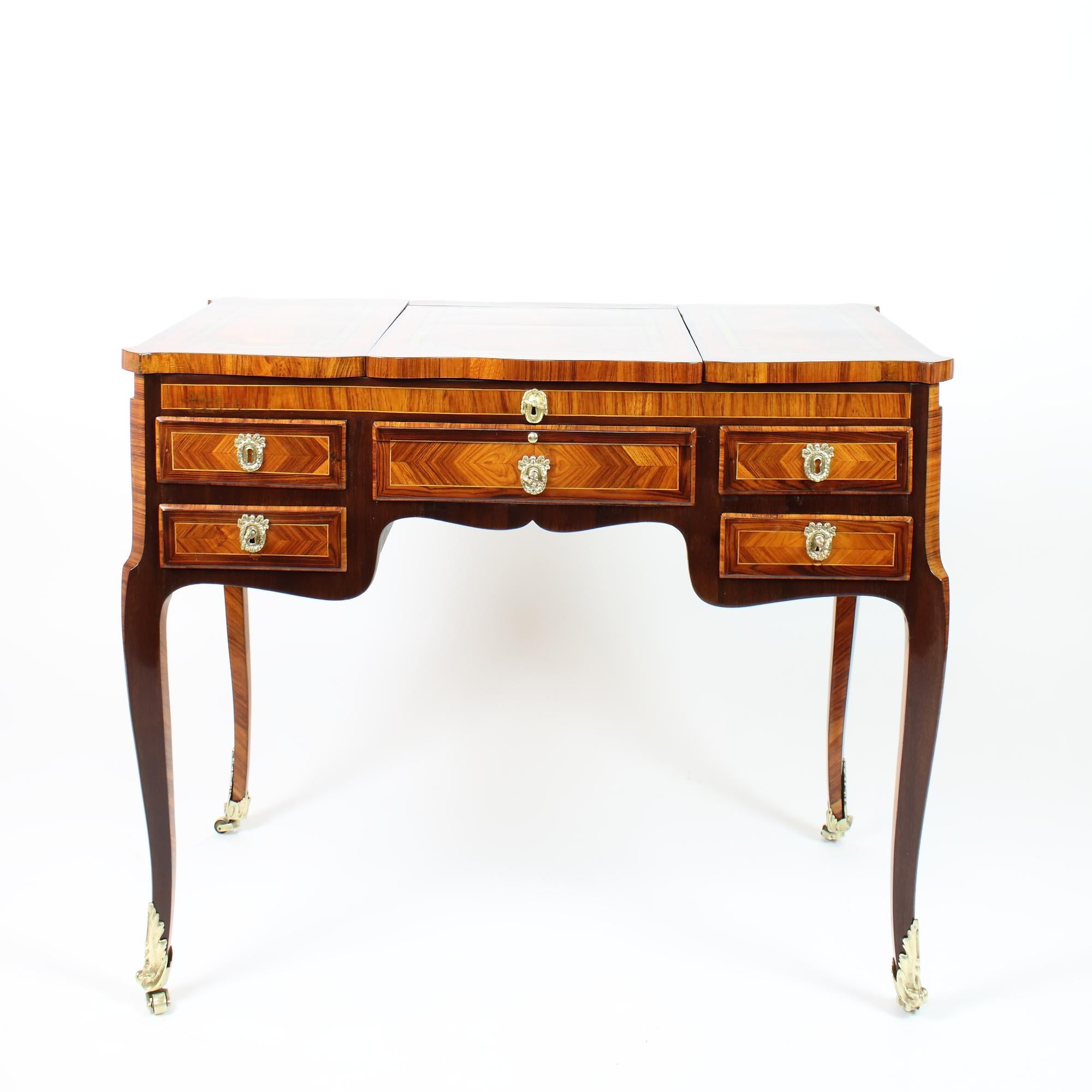 18th Century French Transition Louis XVI Marquetry Vanity or Coiffeuse

Rectangular corpus standing on four slender cabriole legs with two small side drawers and one central frieze drawer. The legs with fine gilt bronze Louis XV style sabots and