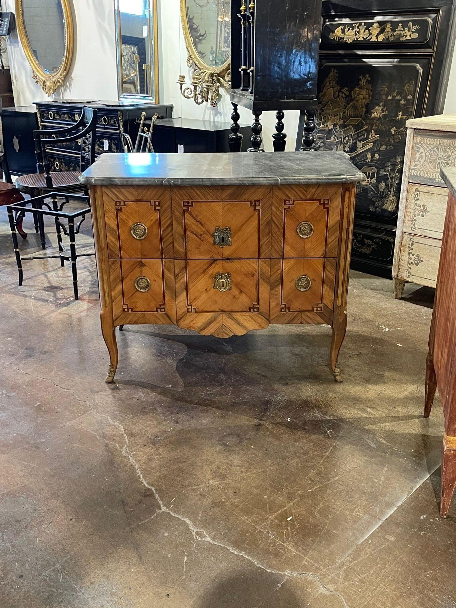 Handsome 18th century French Transitional inlaid walnut commode with a beautiful marble top. Creates a real touch of elegance. Gorgeous!!.