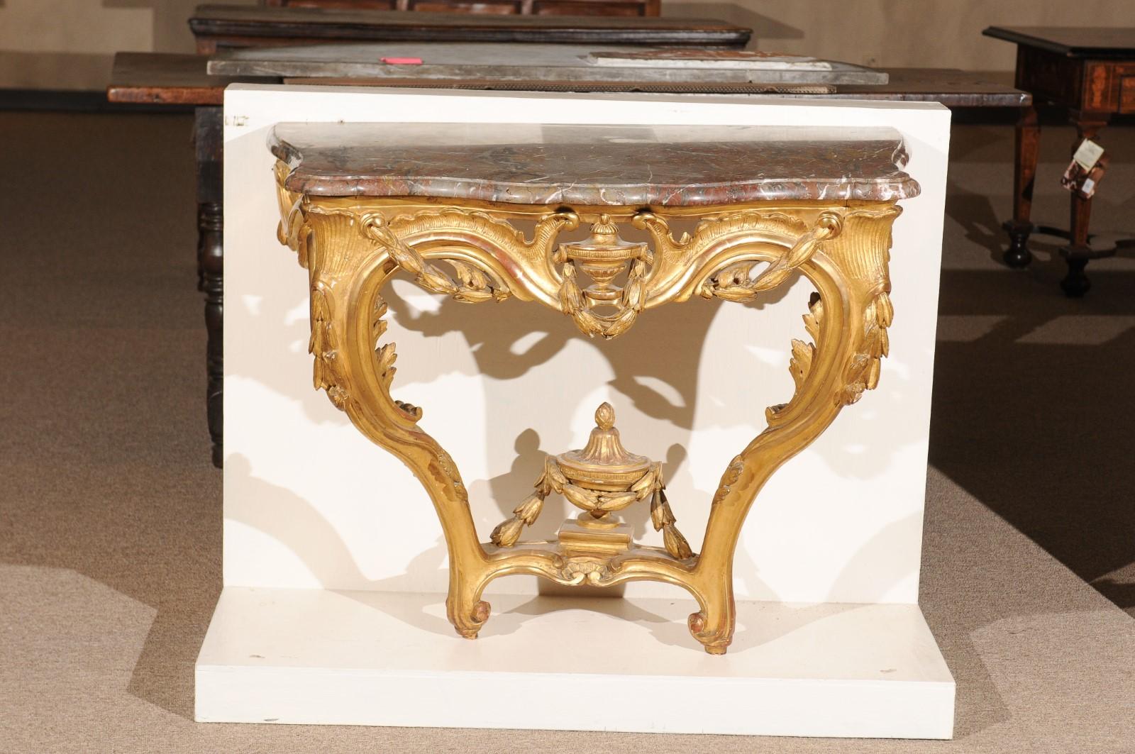Transitional Louis XV/XVI wall-mounted giltwood console table with urn finial & marble top.