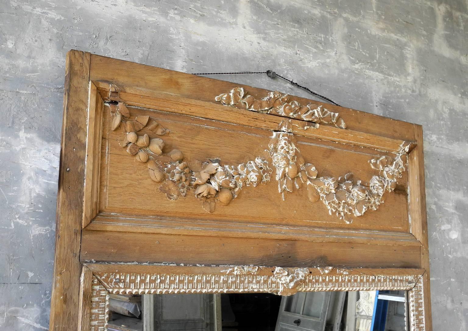 This is a beautifully carved antique 18th century trumeau mirror from the boiseried dining room of a 