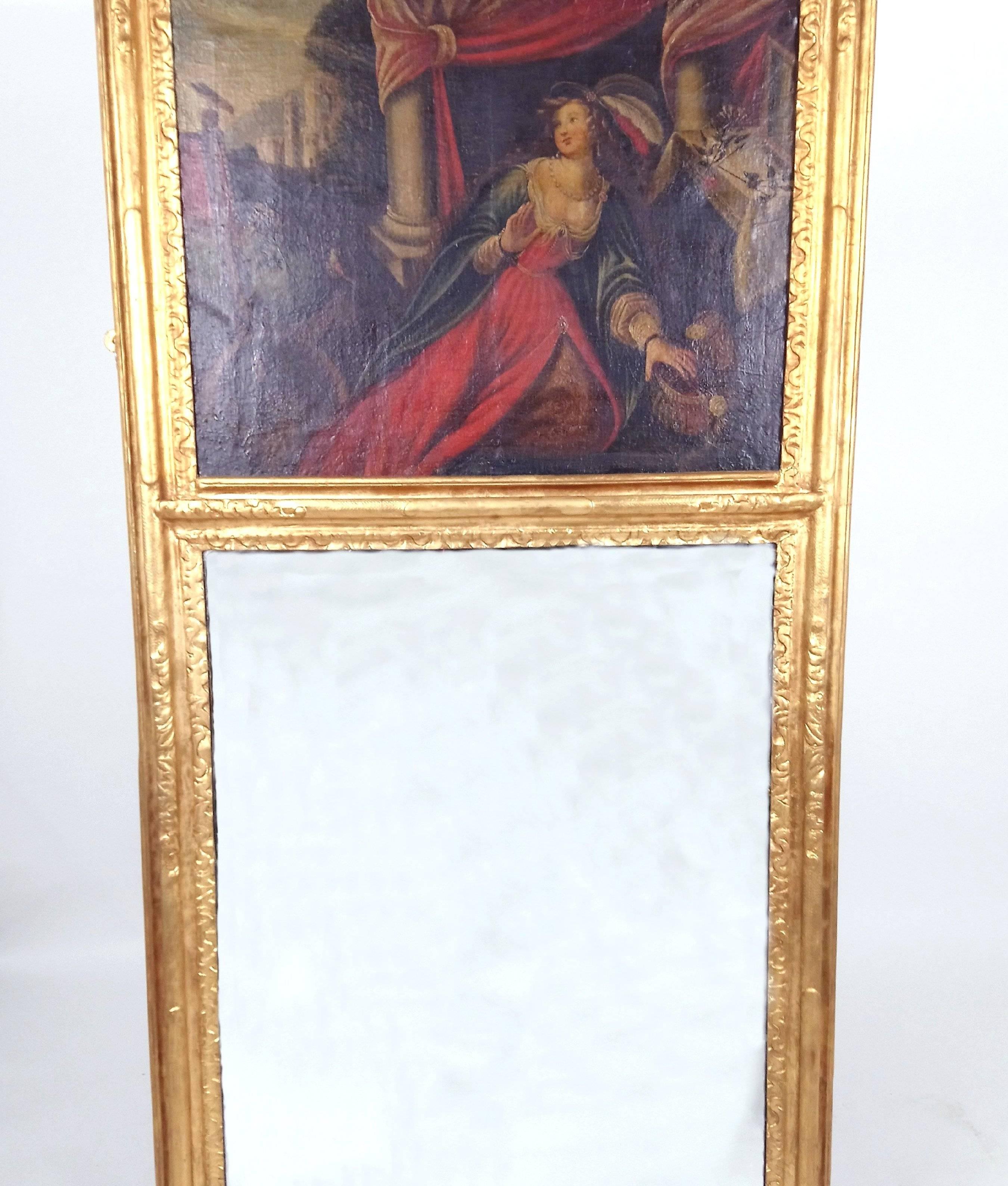 This late 18th century French giltwood wall mirror depicts a young woman of the period captured in a reclined poise, with her attention focused offside. The mirror measures 69 ½ in – 176.5 cm in height by 31 ½ - 80 cm wide, with a depth of 1 ¾ in -