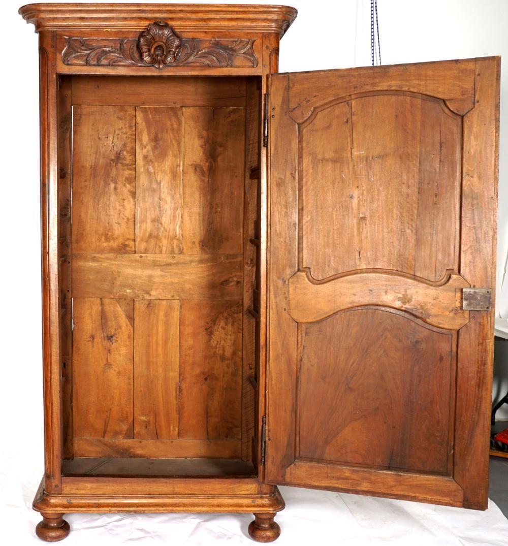 Early 18th century French walnut bonnetiere or small wardrobe armoire. Beautiful patina of walnut, original finish, one door with nice original carvings.

Great size.

  