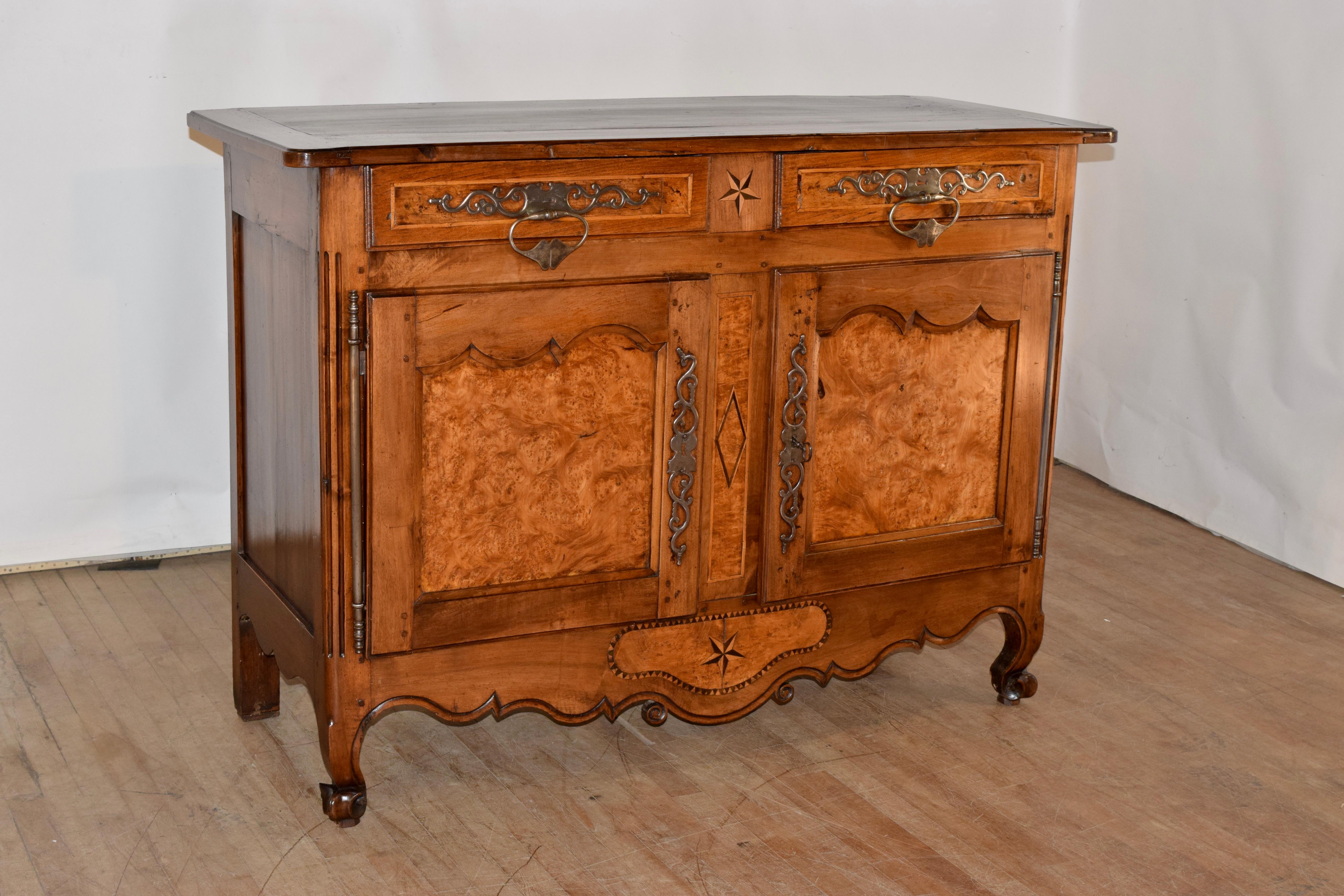 18th century walnut buffet from France with gorgeous burl walnut details throughout the piece. The top is banded and has a beveled edge, following down to hand paneled sides with scalloping on the skirt. There are two drawers, both banded in boxwood