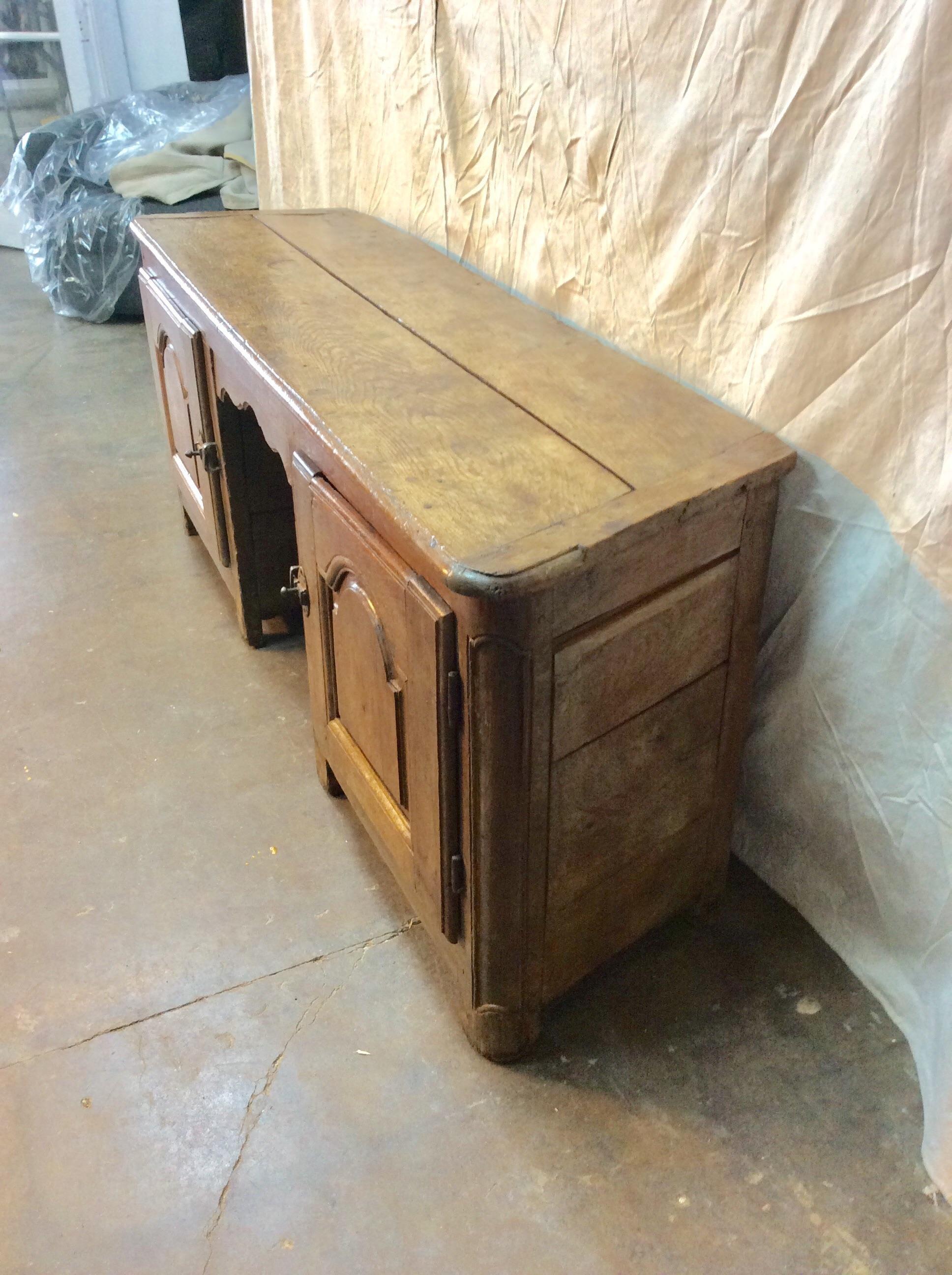 Found in the South of France, this 18th Century French Walnut Cabinet or Console features a two planked top finished with the classic French bread board ends. Wood pegged and hand carved, this piece is constructed with canted angle sides and two