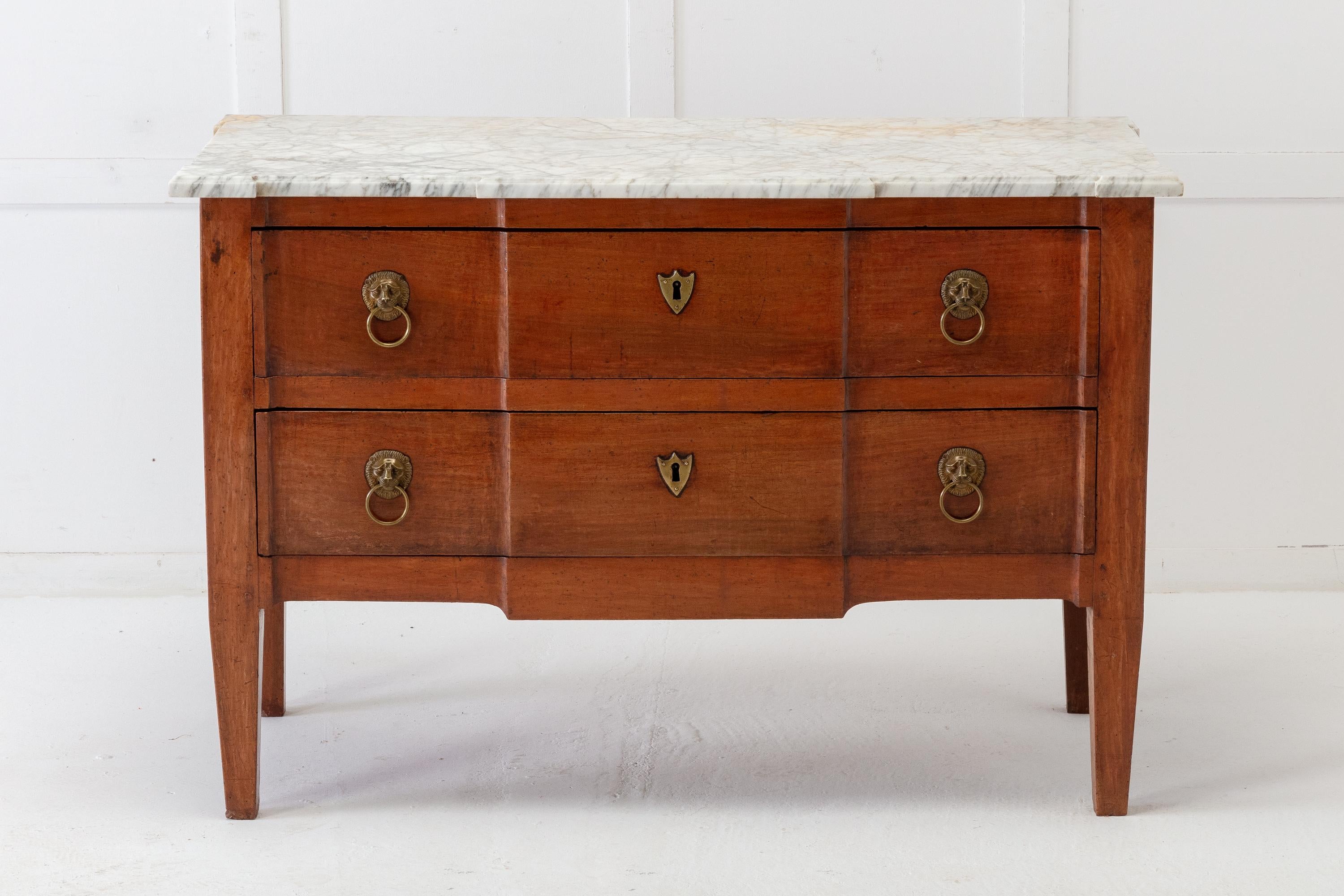 18th century French, breakfront, walnut chest of drawers with original marble top. Having two drawers with lion's head pull handles. The sides are panelled. Terminating on square tapering legs.
 