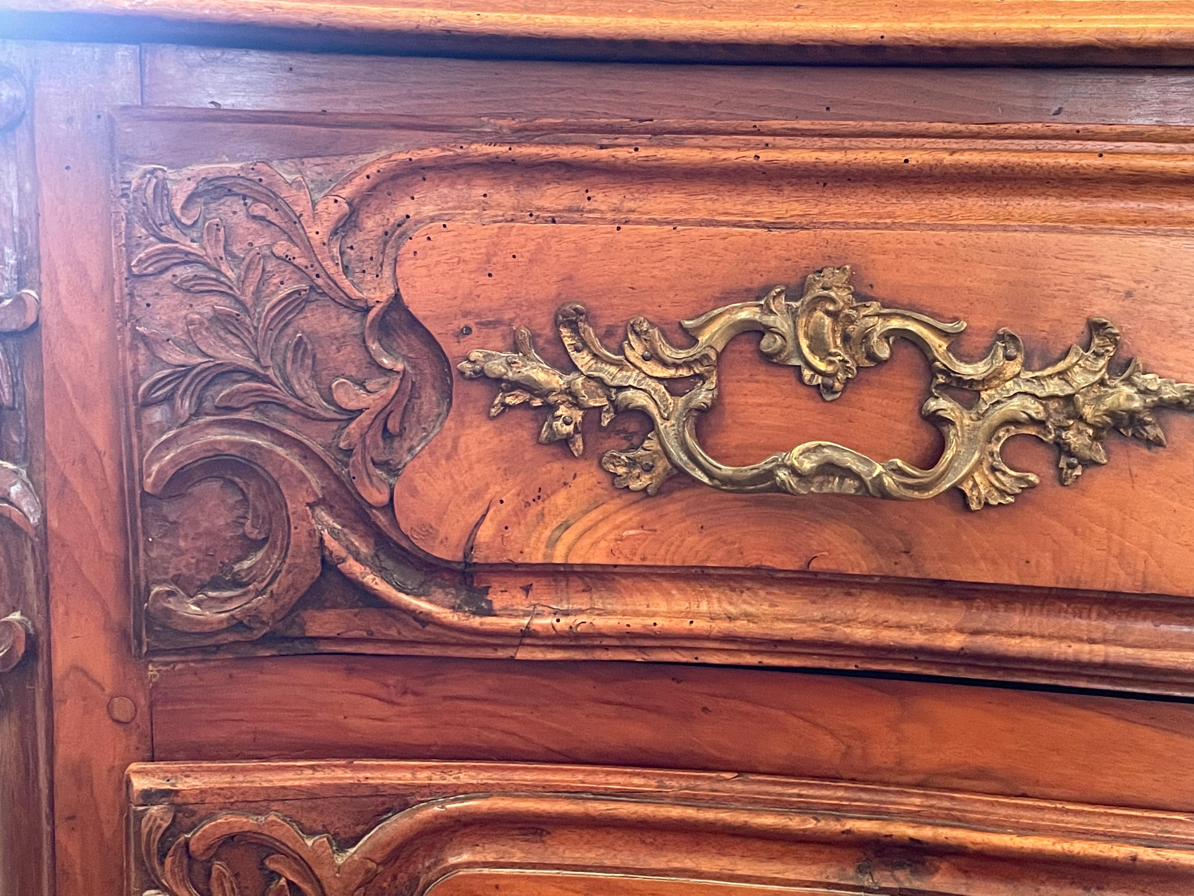 Hand-Carved 18th Century French Walnut Commode with Brass Fixtures For Sale