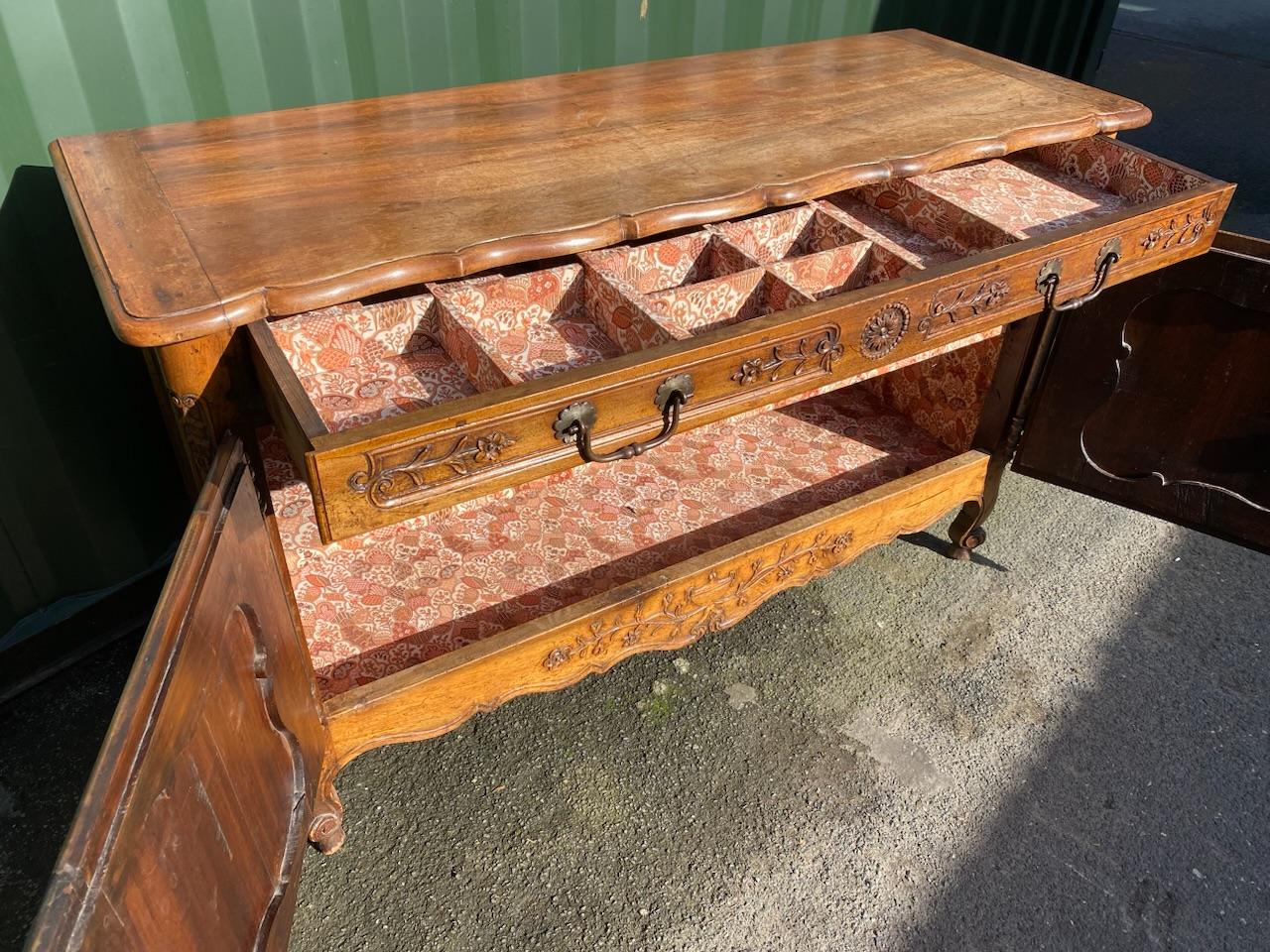 A beautiful French 18th century walnut cupboard or small sideboard. Lovely original mellow colour and patina. Covered in lovely carved decoration and having a long drawer to the top and 2 lockable cupboard doors under. Original back and in very good