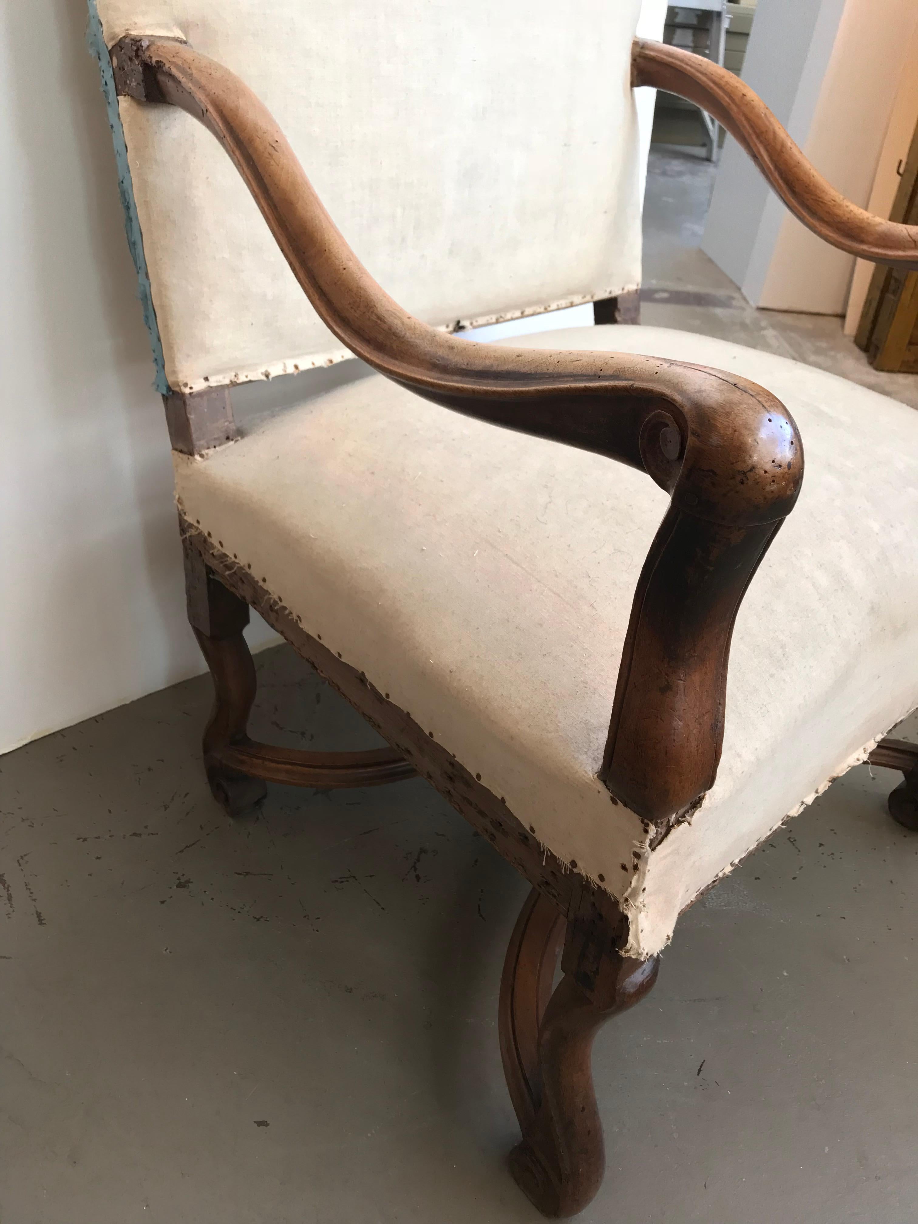18th century French walnut Louis XIII chair with nailheads and cream upholstery.
 