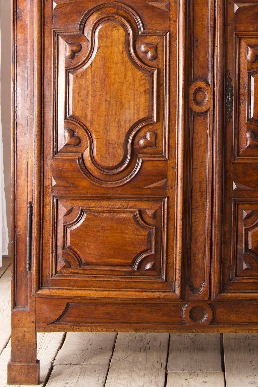 This is a simply beautiful and rare piece of French folk art. It is an 18th century Marriage cupboard made from solid walnut. The whole cupboard is in totally original condition which is rare to see. The only additions have been to the interior