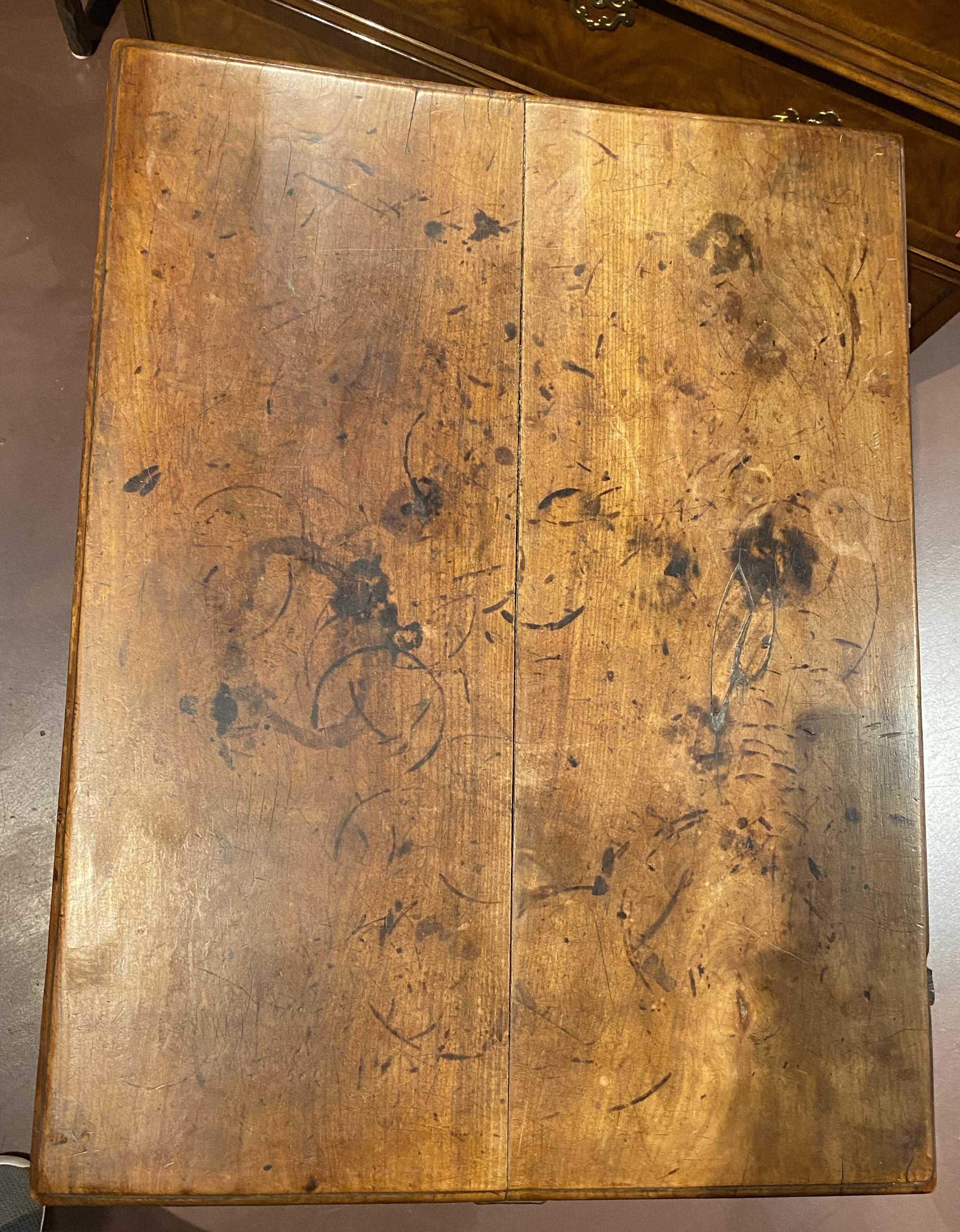 A nice example of an 18th century French walnut tavern table with single divided drawer, removable pegged two board top (pegs missing), scalloped apron, and splayed turned legs with base stretchers. Great overall patina, with some surface